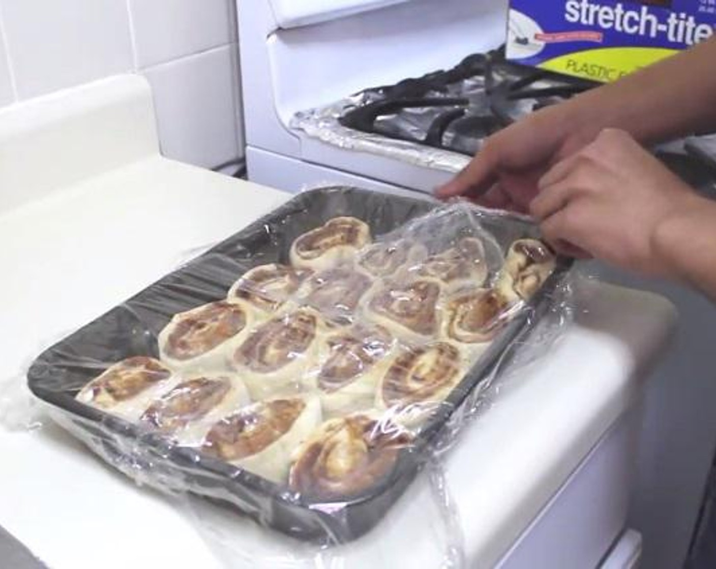 step 8 Roll the dough into a log and cut it into 14 to 16 slices. Place the rolls into a baking pan and cover them with a plastic and set aside for about 30 minutes.