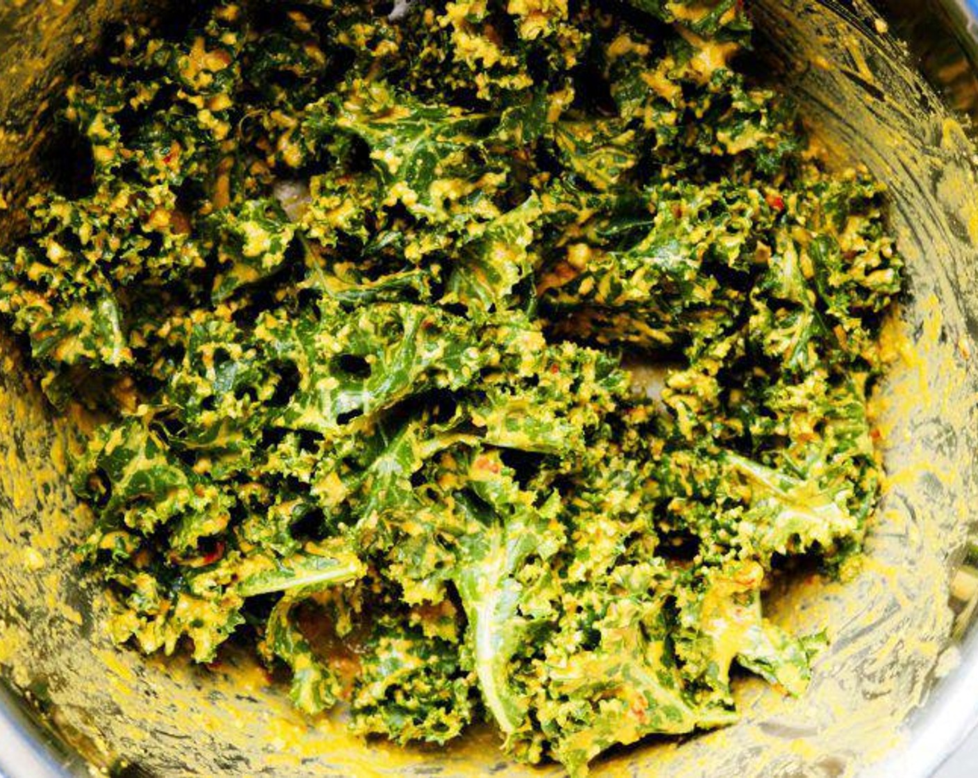 step 5 Transfer the cashew cheese mixture to the prep bowl containing the kale leaves. With gloved hands, massage the cheese mixture into the kale ensuring each piece is well-coated front and back.