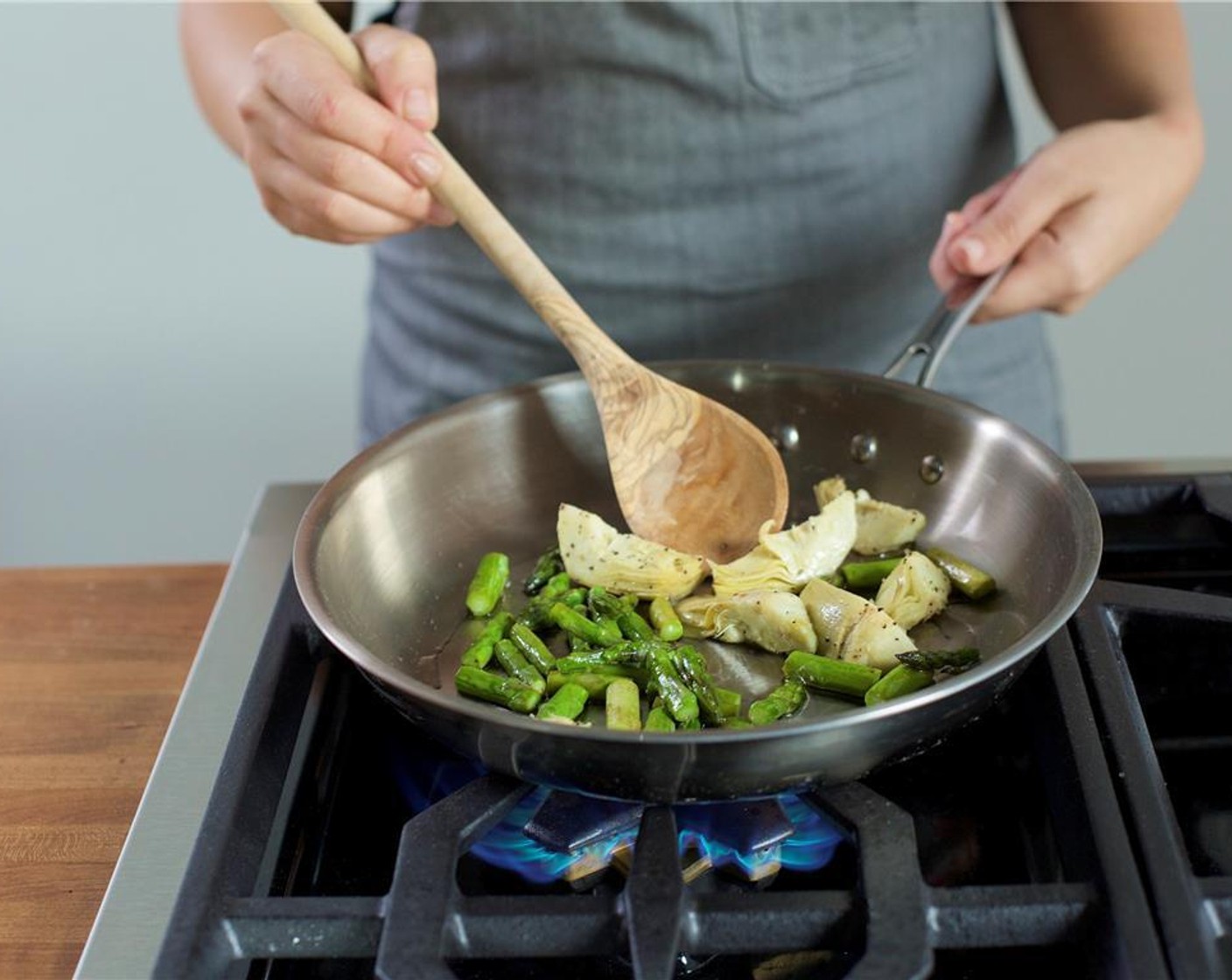 step 7 Heat a medium saute pan over high heat with one teaspoon of olive oil. Add the asparagus, artichoke hearts, Salt (1/4 tsp) and Ground Black Pepper (1/4 tsp). Toss and cook for two to three minutes. Remove from heat and set aside.