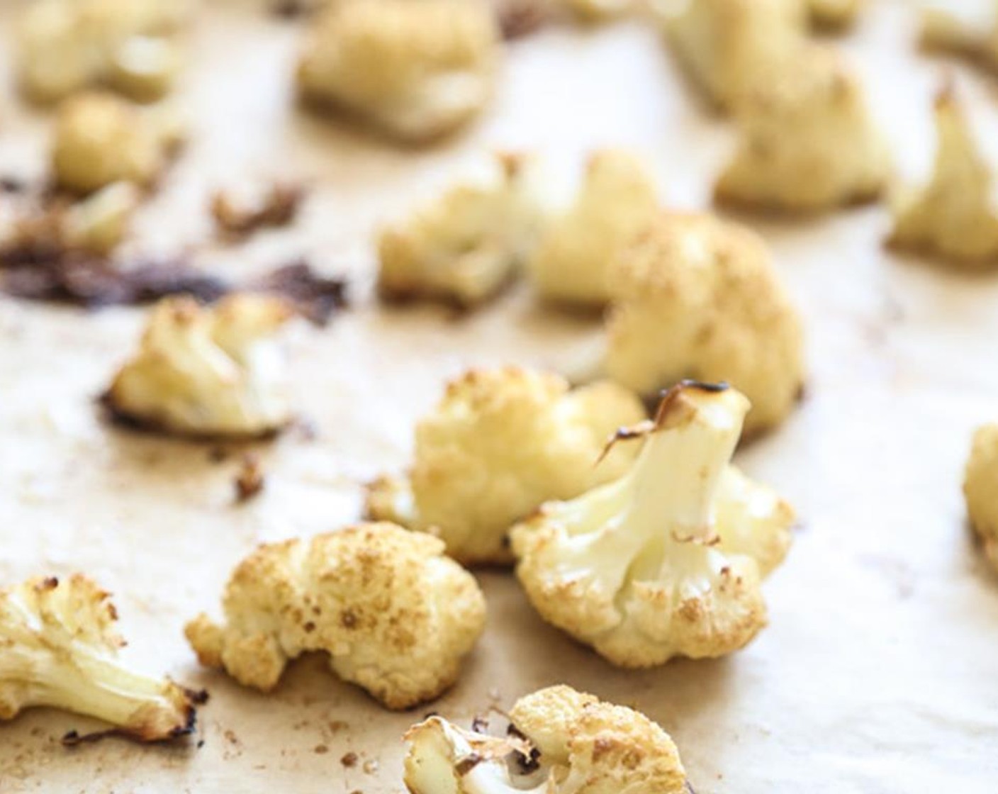 step 2 On a parchment-lined baking sheet, toss the Cauliflower (1) with Extra-Virgin Olive Oil (1 Tbsp), Ground Cumin (1/2 tsp), and Sea Salt (1/2 tsp).