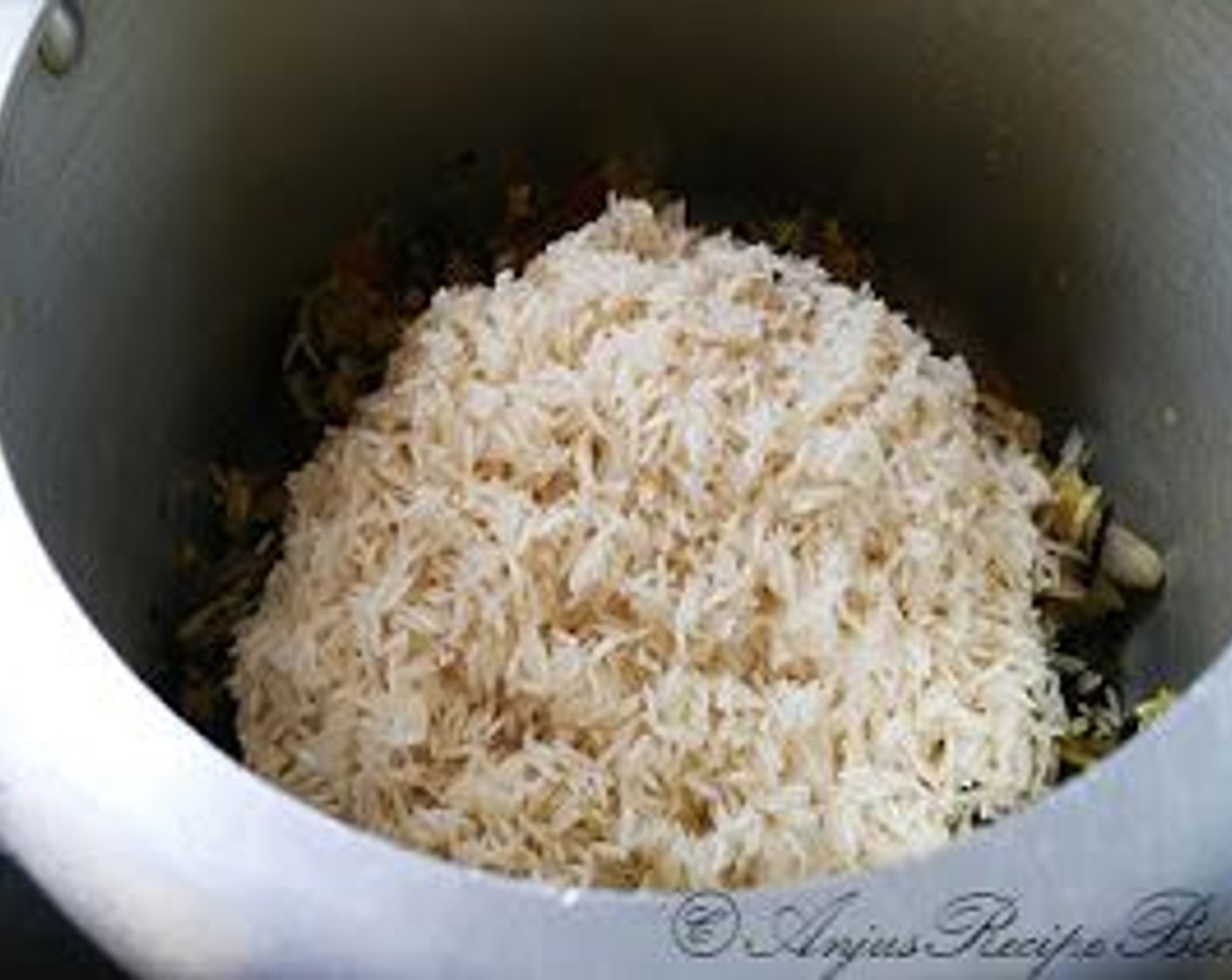 step 5 To a pressure cooker put the marinated chicken along with the marinade. Add washed rice.