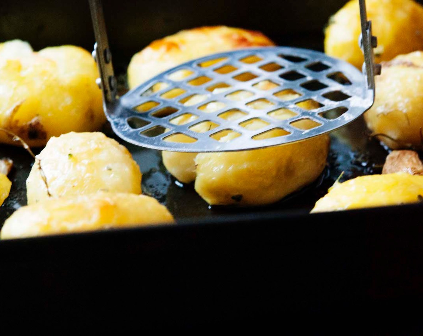 step 6 Remove the potatoes from the oven. With a potato masher or the bottom of a small glass, gently smash potatoes into flat patties.