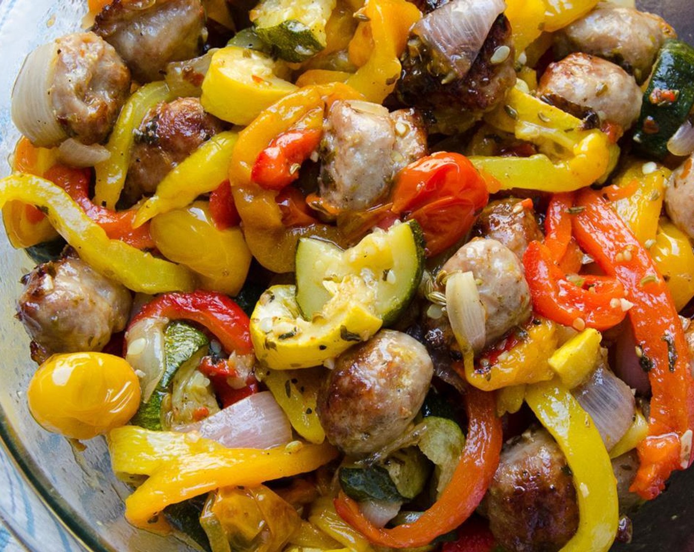 step 8 Add the roasted vegetables and sausage to the peppers. Scrape the pan to get all of the juicy goodness into the bowl.