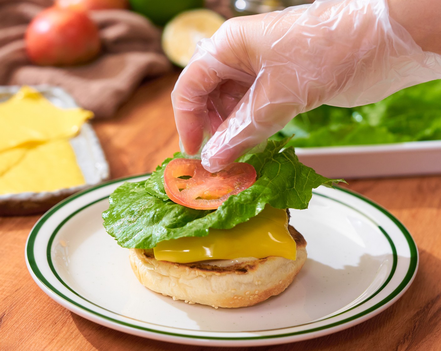 step 8 Slather hamburger buns with mayo sauce on one side of the bun. Then top each hamburger with a piece of beef patty, American Cheese (6 slices), Pickled Cucumbers (2), Lettuce (6 pieces), and Tomatoes (6 slices). Serve immediately.