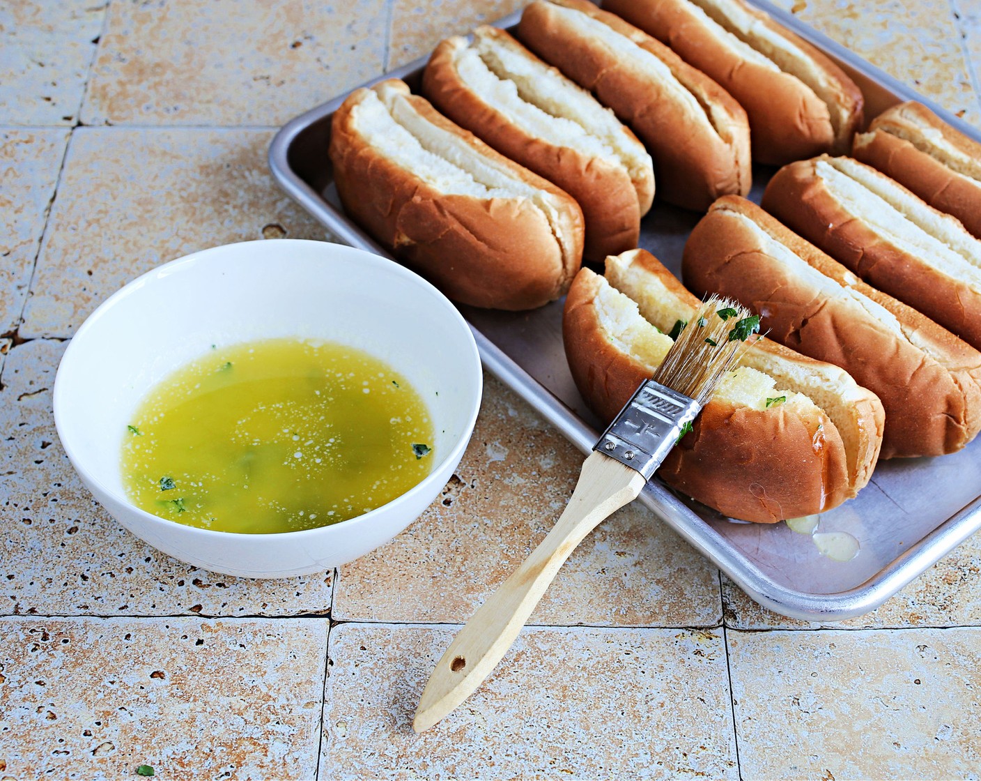 step 3 Place the Hot Dog Buns (8), cut side up, on a baking sheet and brush with the butter mixture. Bake for 10 minutes.