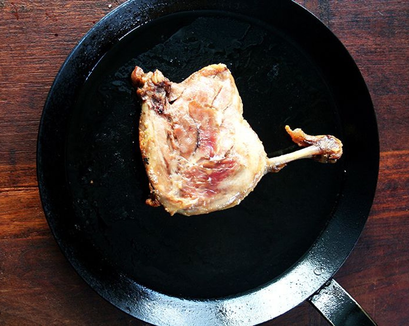 step 10 Heat a cast iron skillet over medium heat. Once hot, add duck legs skin side down. Let them crisp undisturbed for 1-2 minutes.