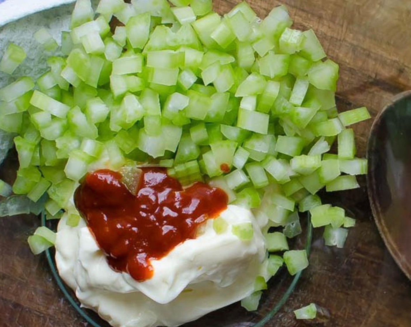 step 4 Dice the Celery (1 stalk). In a large bowl, combine the Mayonnaise (1/2 cup), celery, Sriracha (1/2 Tbsp), zest and juice from Lime (1/3), Kosher Salt (1/4 tsp), Fresh Cilantro (2 Tbsp) and Freshly Ground Black Pepper (to taste).