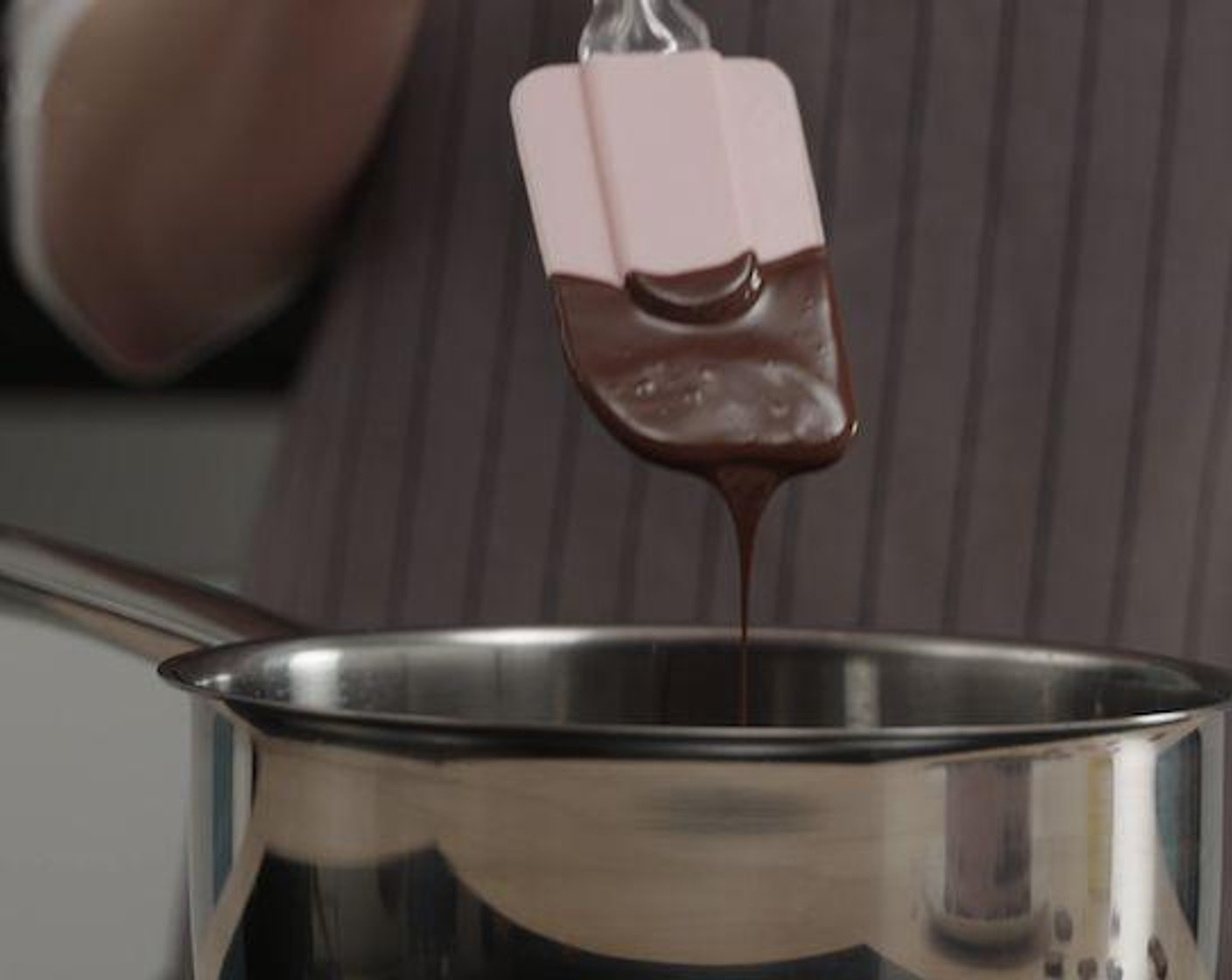 step 3 To know when the chocolate is completely melted, look for a smooth, glossy film when a spatula is pulled through.
