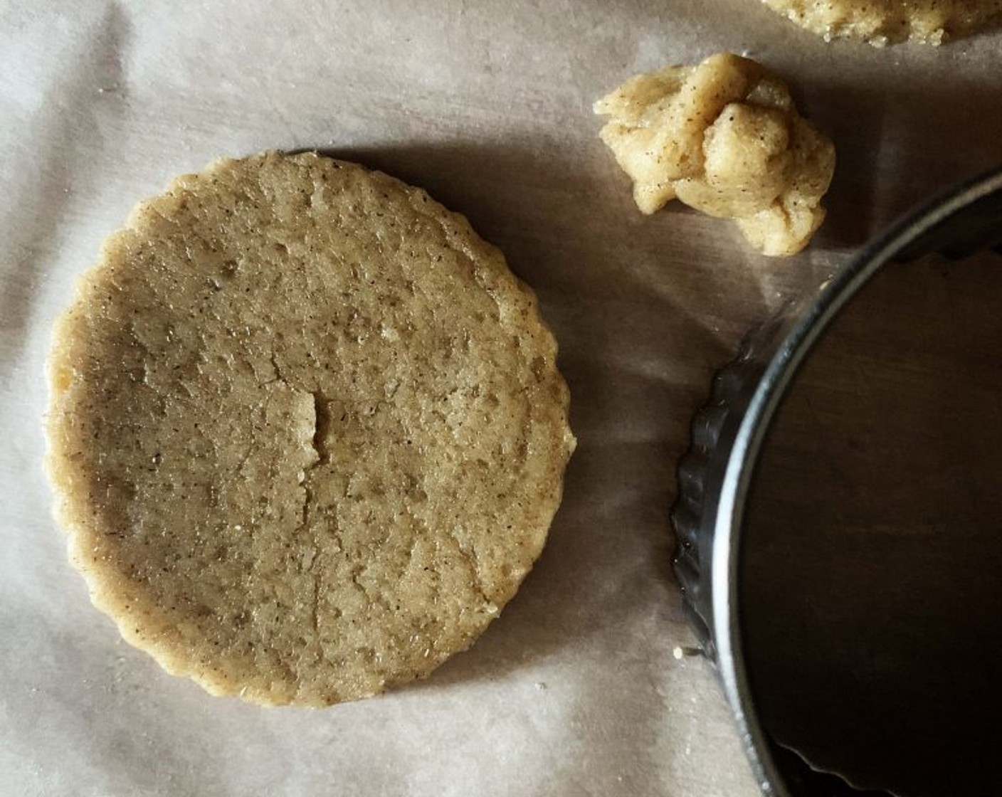 step 4 Place the dough between 2 parchment sheets. Flatten the dough with a rolling pin, cut it into shapes with any favorite cookie cutter, and place the cookie onto the parchment-lined tray.