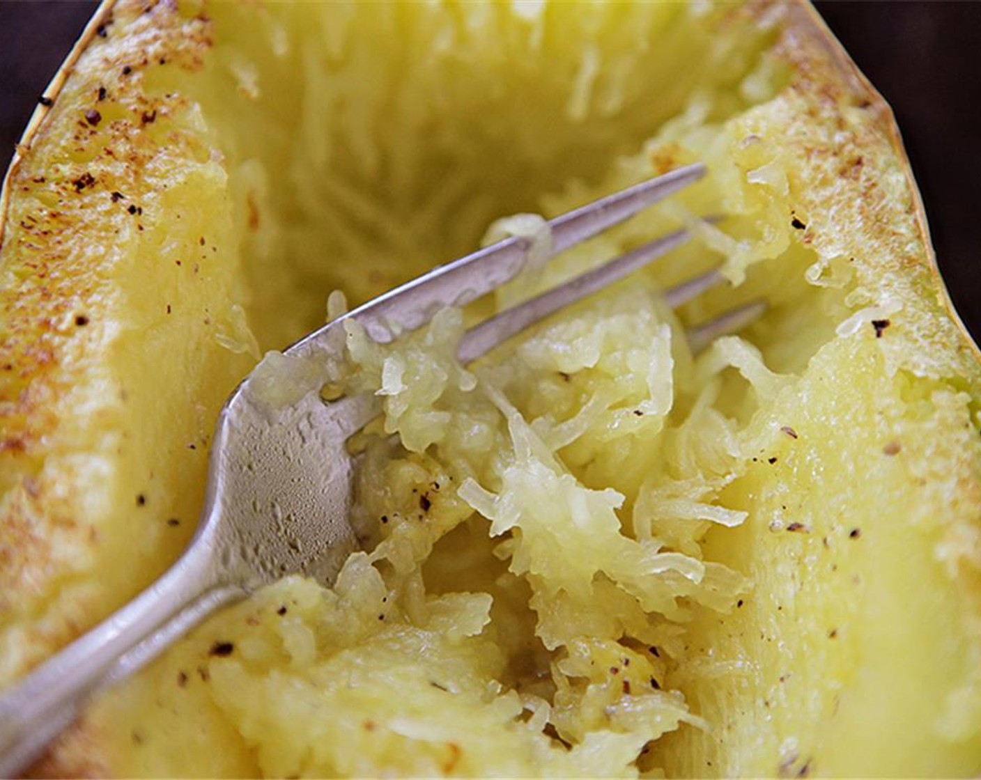 step 10 Once the squash is cooked, remove from the oven and allow to cool for 5-10 min. Scrape out the inner strands of squash and add to the pan with eggplant.