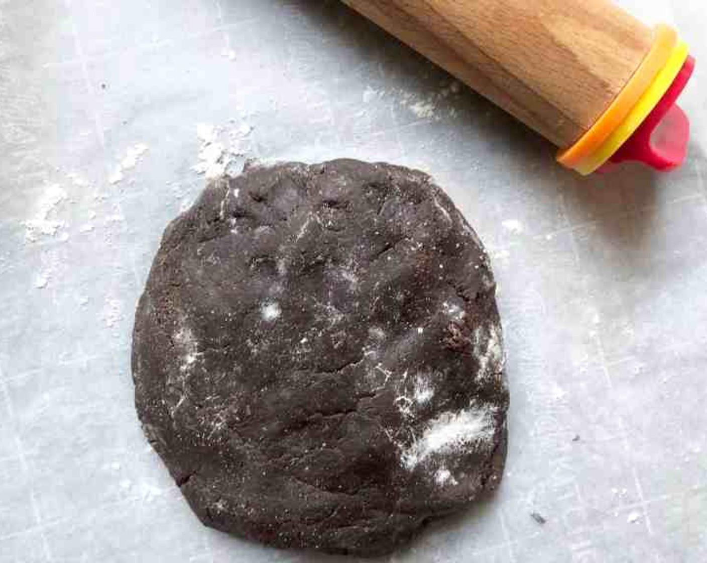 step 6 Roll out the dough to 1/8-inch thickness on a lightly floured board. (Or between two sheets of parchment or waxed paper.)