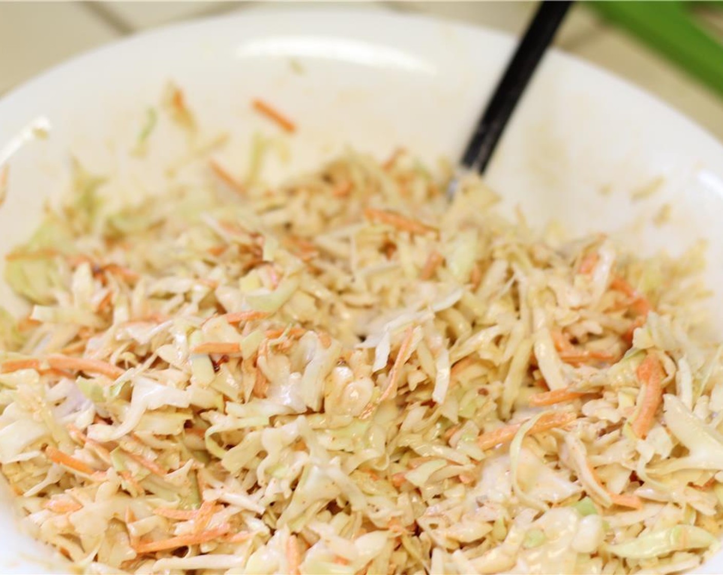 step 13 Add the dressing in batches to the Coleslaw Mix (1 pckg). You may not need all of it. You just want to coat the coleslaw, not drown it. Refrigerate while you wait for the pork to finish.