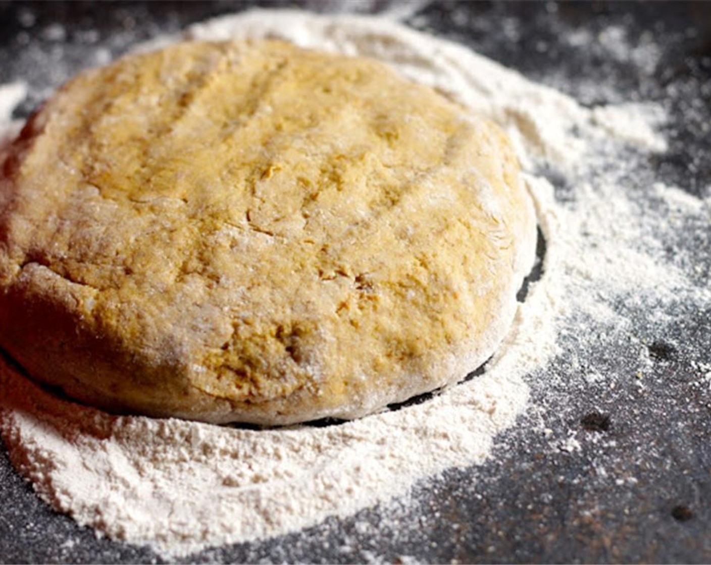 step 5 Scoop dough out onto a floured surface and knead lightly with additional flour until dough is is no longer sticky. Pat into one large round wheel (or two small ones will work fine as well).