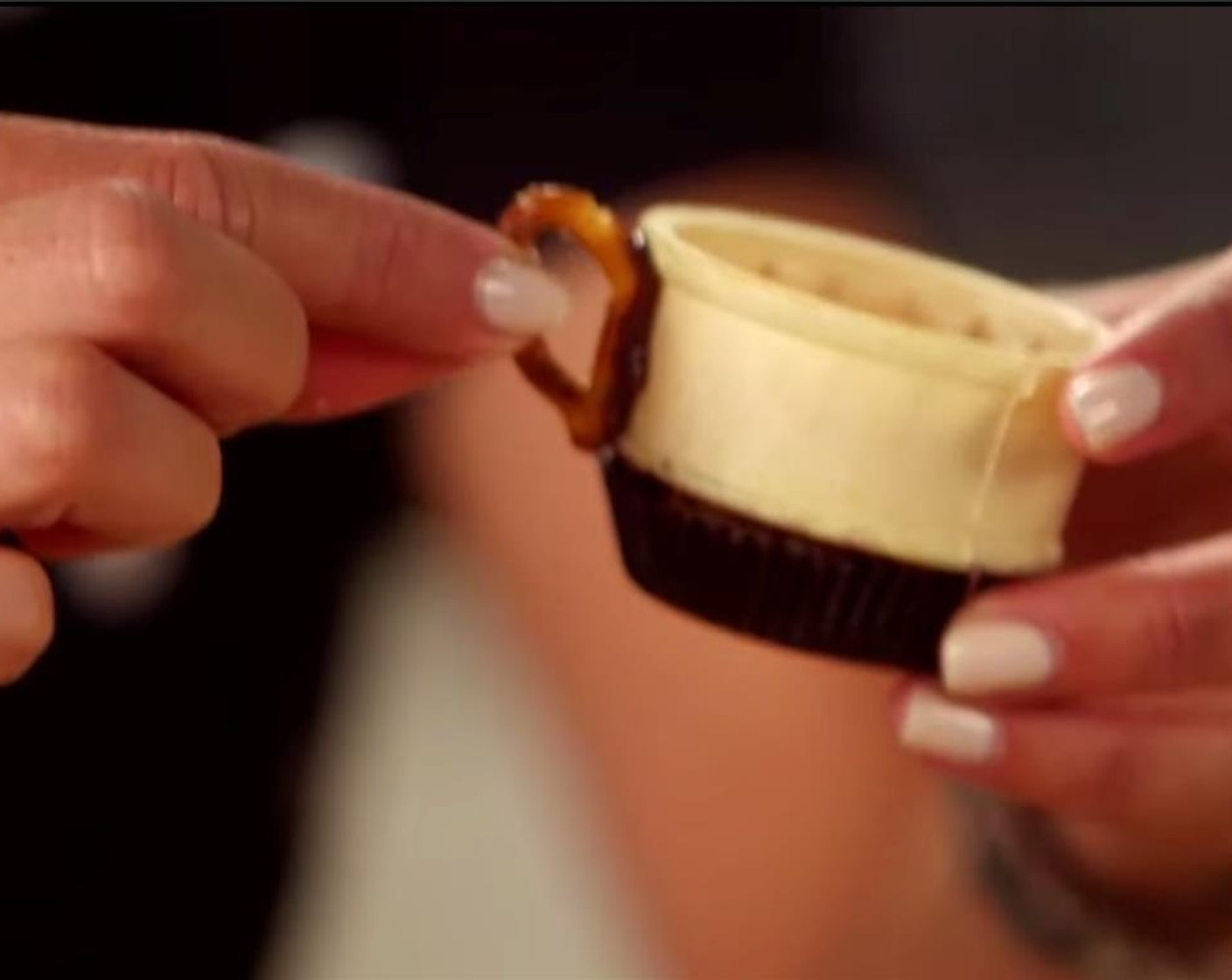 step 3 Cut off the part of the Mini Pretzels (1 handful) to form the handle of the teacup, dip one end in the melted chocolate and attach to the teacup. Place teacups in the refrigerator for a few minutes to set.