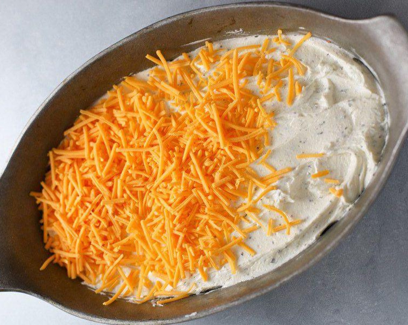 step 4 Spread half the Cheddar Cheese (1 cup) and half the Mozzarella Cheese (1 cup) on top of the cream cheese base.