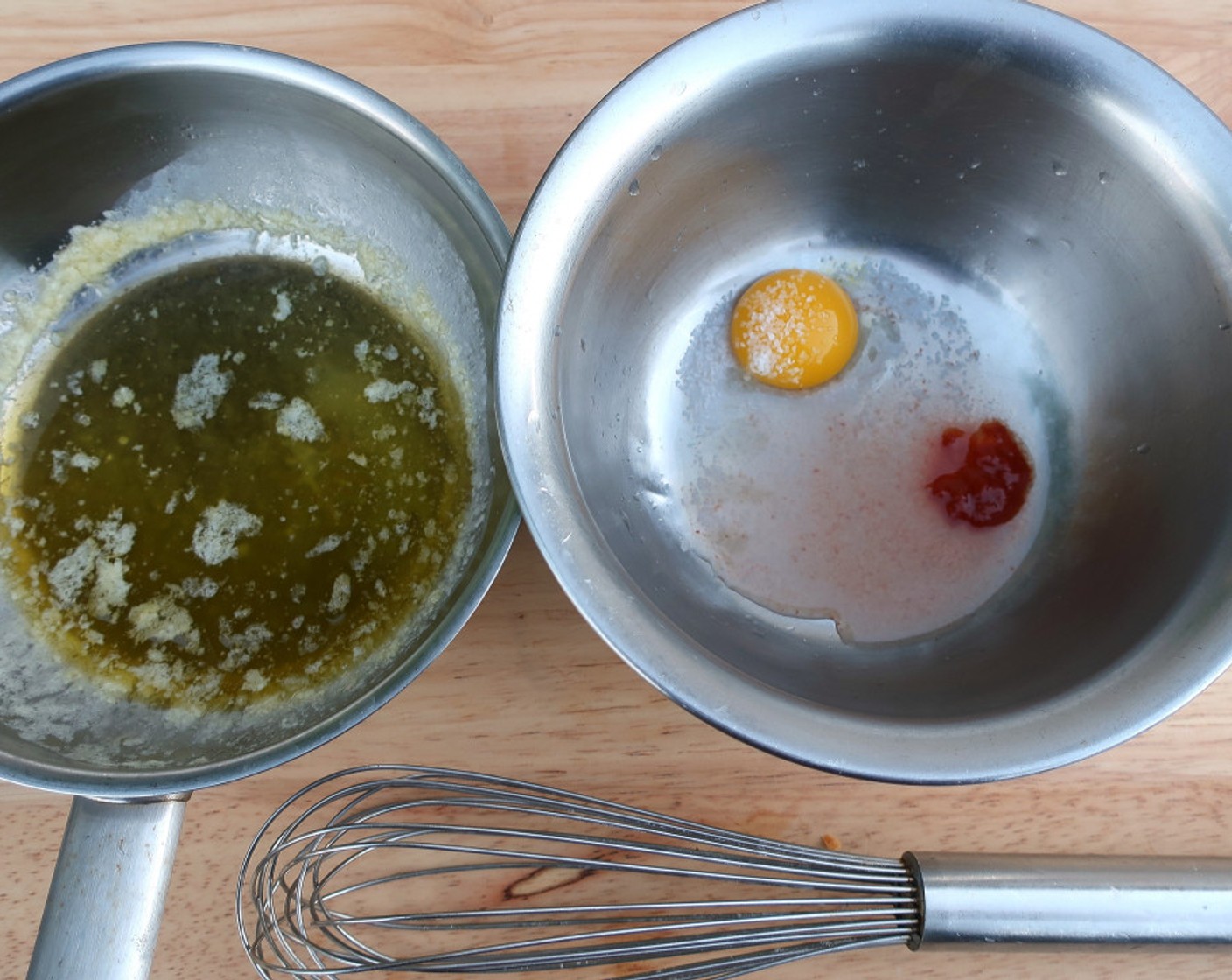 step 7 In a mixing bowl, whisk the Egg (1), Water (1 Tbsp), juice from Lemon (1), Sriracha (to taste), and Kosher Salt (to taste) in a water bath until the egg mixture becomes creamy.