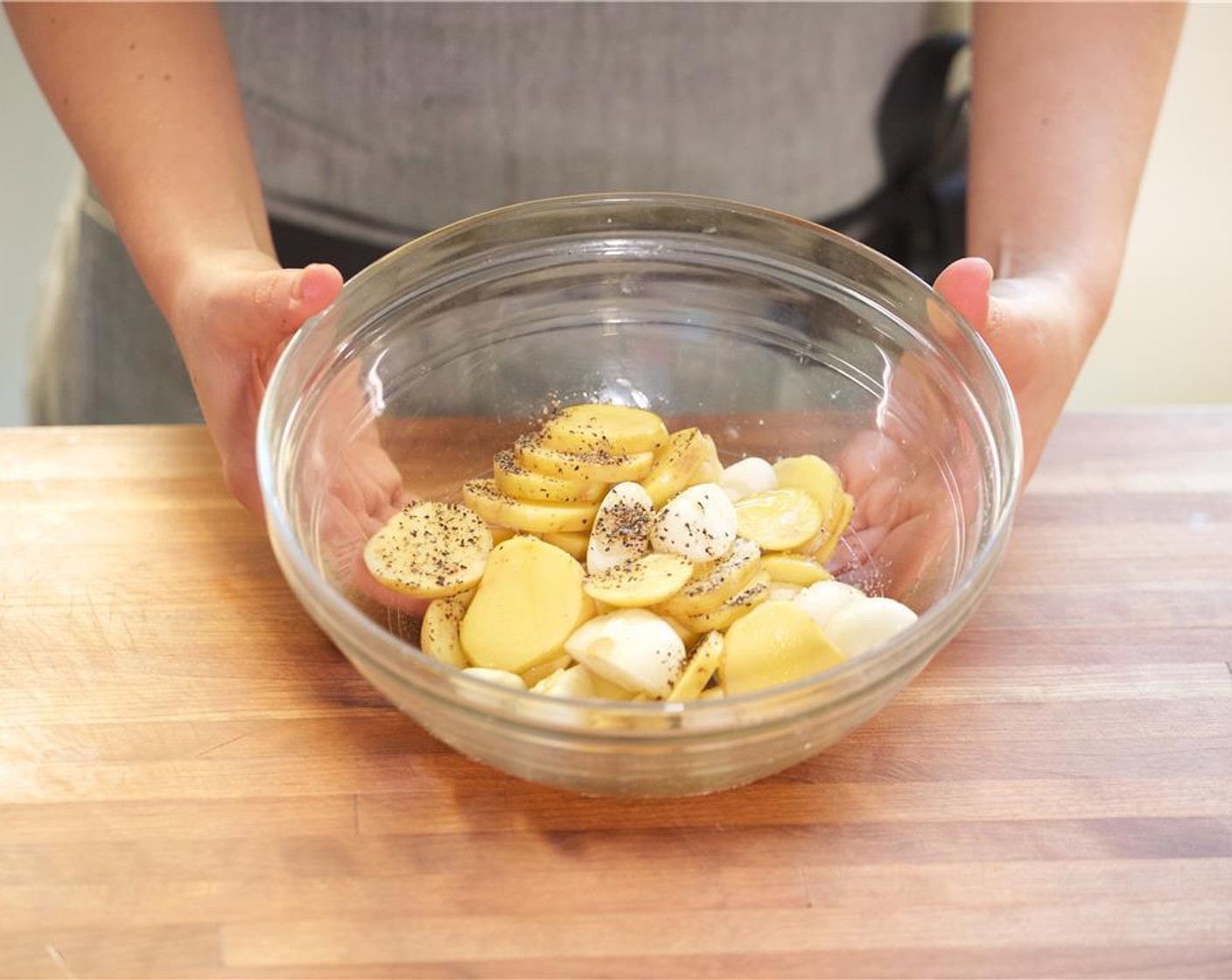 step 9 Add Olive Oil (1/2 Tbsp), Salt (1/4 tsp) and Ground Black Pepper (1/4 tsp) to the bowl with the onions and potatoes. Mix until well combined.