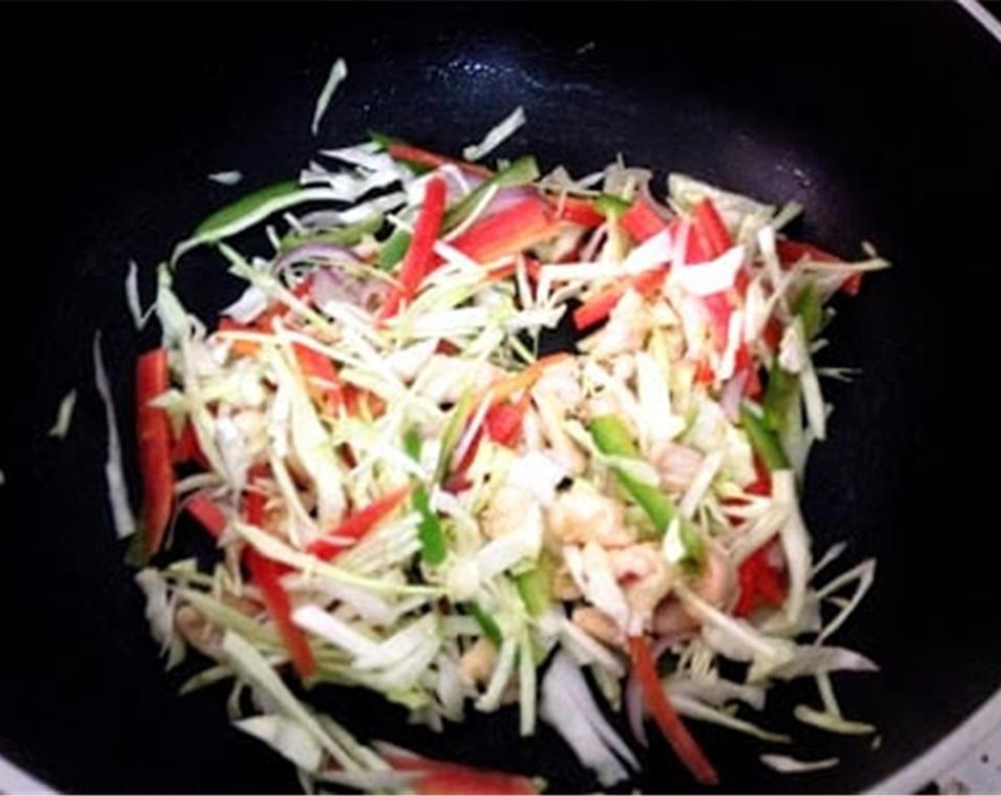 step 2 Add Oil (2 Tbsp) to a pan. Once the oil is hot, add Green Chili Pepper (1), Green Cabbage (1/2 cup), Carrot (1/2 cup), Bell Peppers (4 Tbsp), and Onion (1). Mix and saute it for 5 minutes.