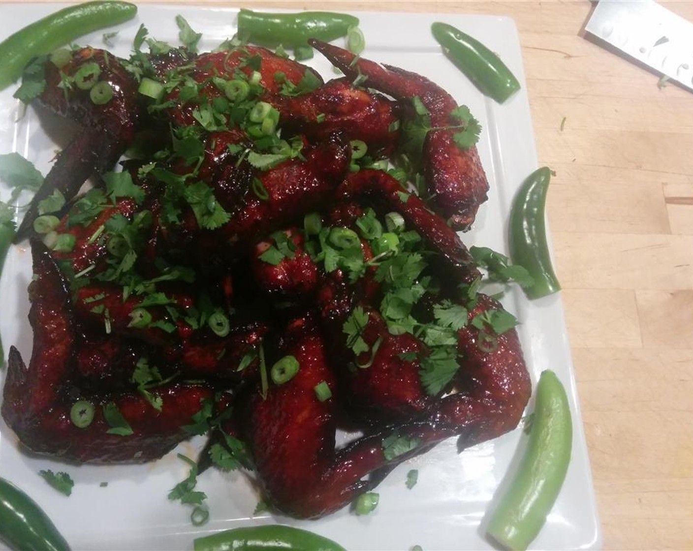 step 11 Toss the wings in the bowl making sure they all get evenly coated.  Garnish with additional scallions and cilantro.