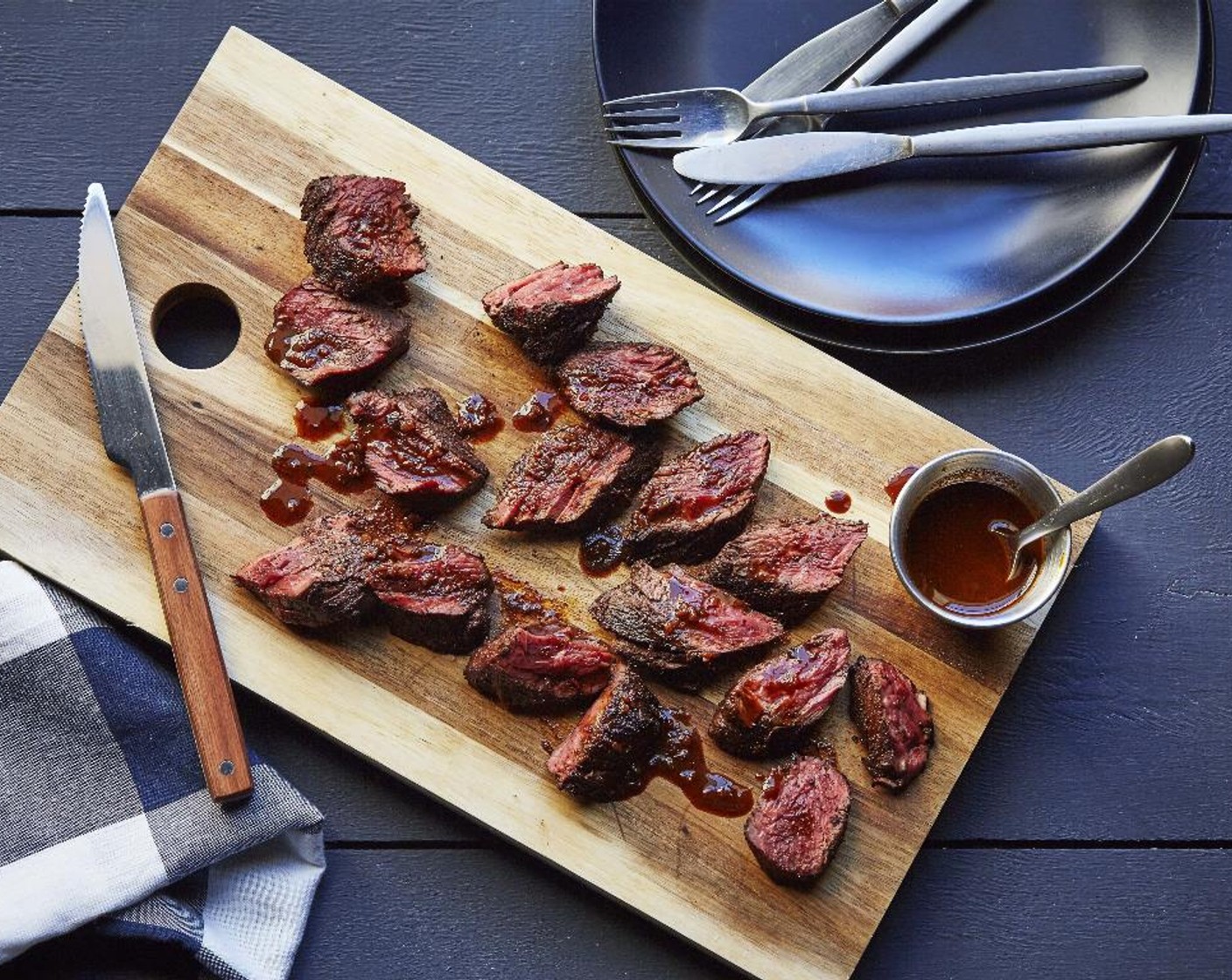 step 11 Slice steak into 1/2 inch slices against the grain. Place the steak over a serving dish. Pour the ancho pan sauce over the steaks and serve and enjoy!