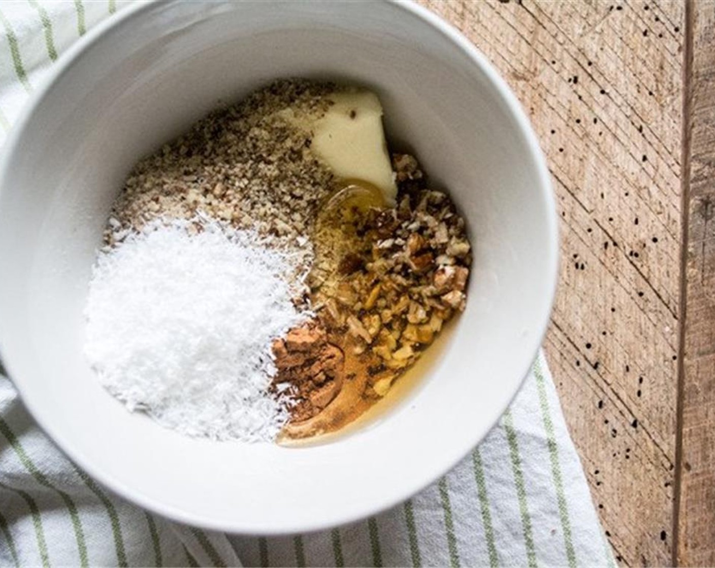 step 3 In small bowl, combine Hazelnut Flour (1/4 cup), Chopped Pecans (1/4 cup), Gluten-Free All-Purpose Flour (1/4 cup), Unsweetened Shredded Coconut (2 Tbsp), Organic Butter (1 Tbsp), Honey (1 Tbsp) and Ground Cinnamon (1 tsp). Stir well to combine. It should be a crumbly mixture.