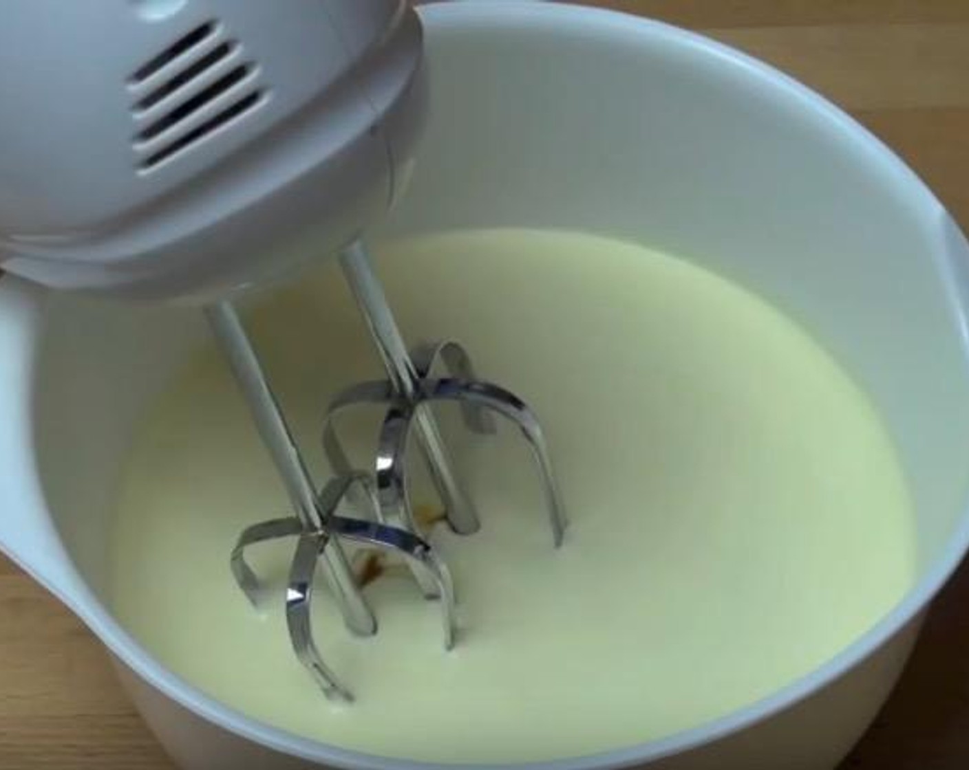 step 5 In a mixing bowl, add Thickened Cream (2 1/2 cups) and Vanilla Extract (1/2 Tbsp). Using an electric mixer, beat until mixture forms soft peaks.