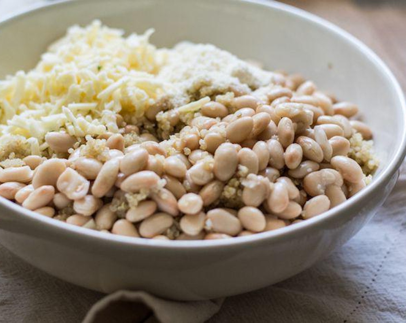 step 4 To a large serving bowl, add cooked quinoa, Canned Great Northern Beans (2 cups), Aged White Cheddar (3/4 cup), and grated Parmesan Cheese (1/4 cup) stir to combine.