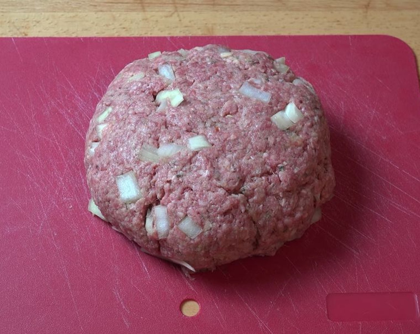 step 2 Into a mixing bowl, add Lean Ground Beef (1.1 lb), Yellow Onion (1/2), Garlic (2 cloves), Egg (1), Italian Seasoning (1/2 Tbsp), and Breadcrumbs (1 1/2 cups). Using your hands, mix together until well-combined. Form the meat mixture into a disk shape.