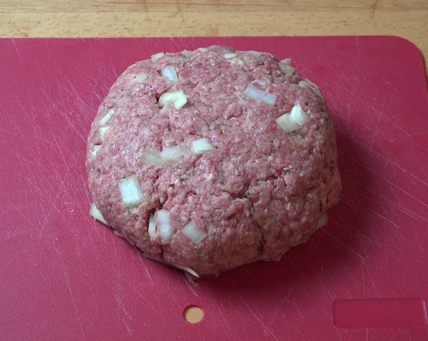 step 2 Into a mixing bowl, add Lean Ground Beef (1.1 lb), Yellow Onion (1/2), Garlic (2 cloves), Eggland's Best Classic Egg (1), Italian Seasoning (2 tsp), and Breadcrumbs (1 1/2 cups). Using your hands, mix together until well-combined. Form the meat mixture into a disk shape.