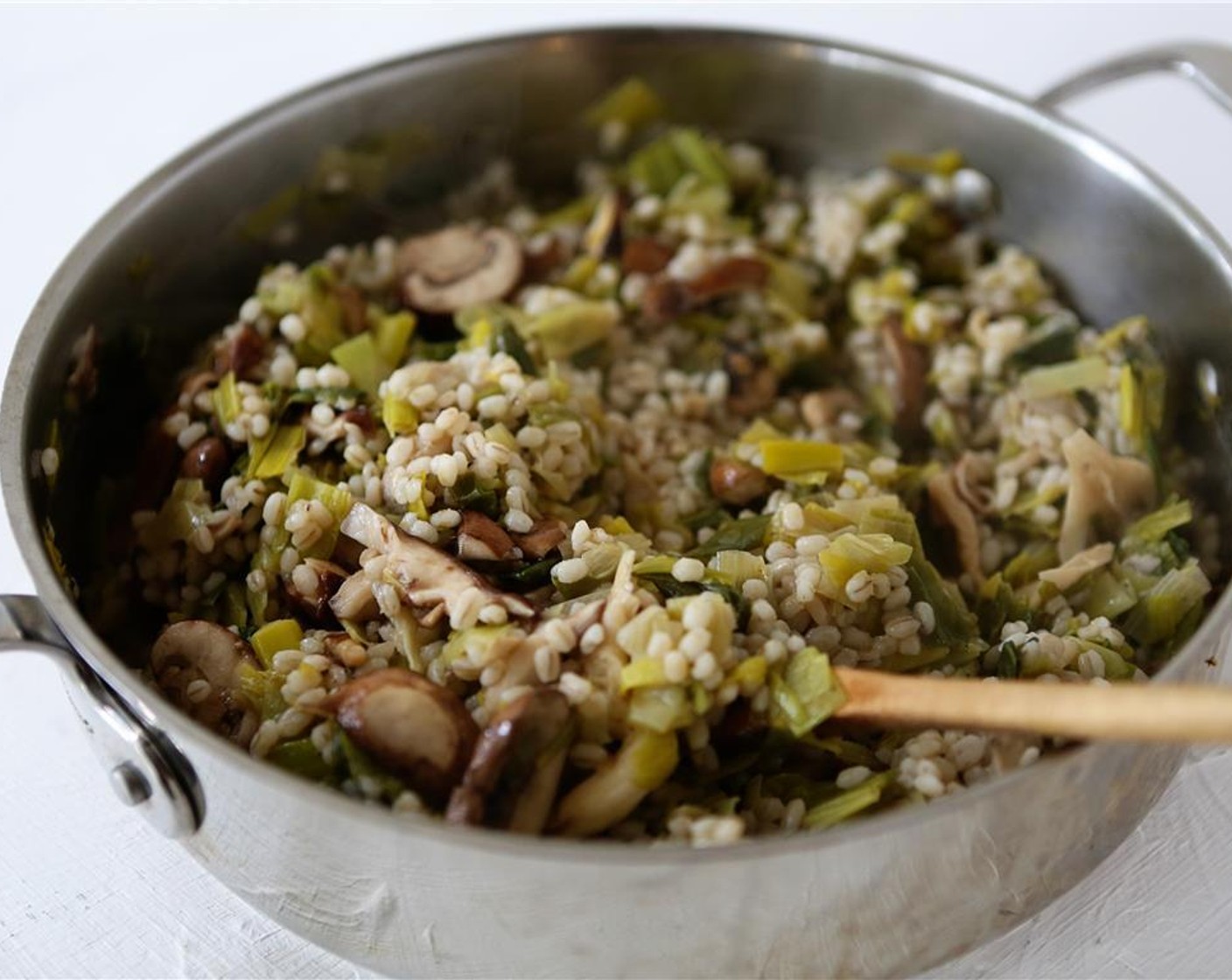 step 9 Once the mixed mushrooms and leeks have cooked, over medium-high heat, add cooked barley and lemon-butter mixture to pan. Cook 2-3 minutes, while stirring, to thoroughly incorporate. Remove pan from heat, discard fresh thyme.