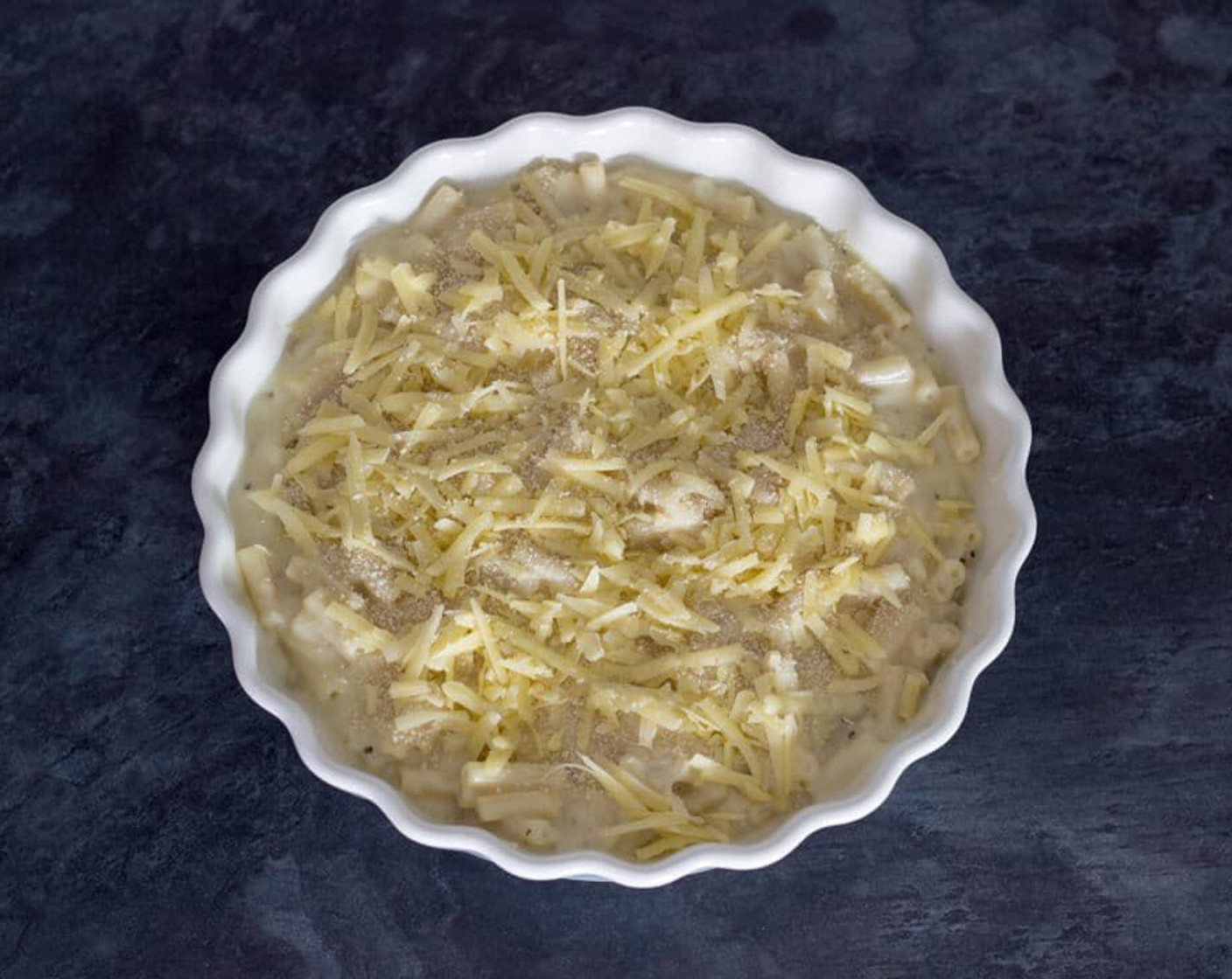 step 8 Tip the sauce over the cooked pasta and give it a good mix. Then go ahead and pour that into your ovenproof dish and scatter over the Mature Cheddar Cheese (1/2 cup) and Breadcrumbs (2 tsp).