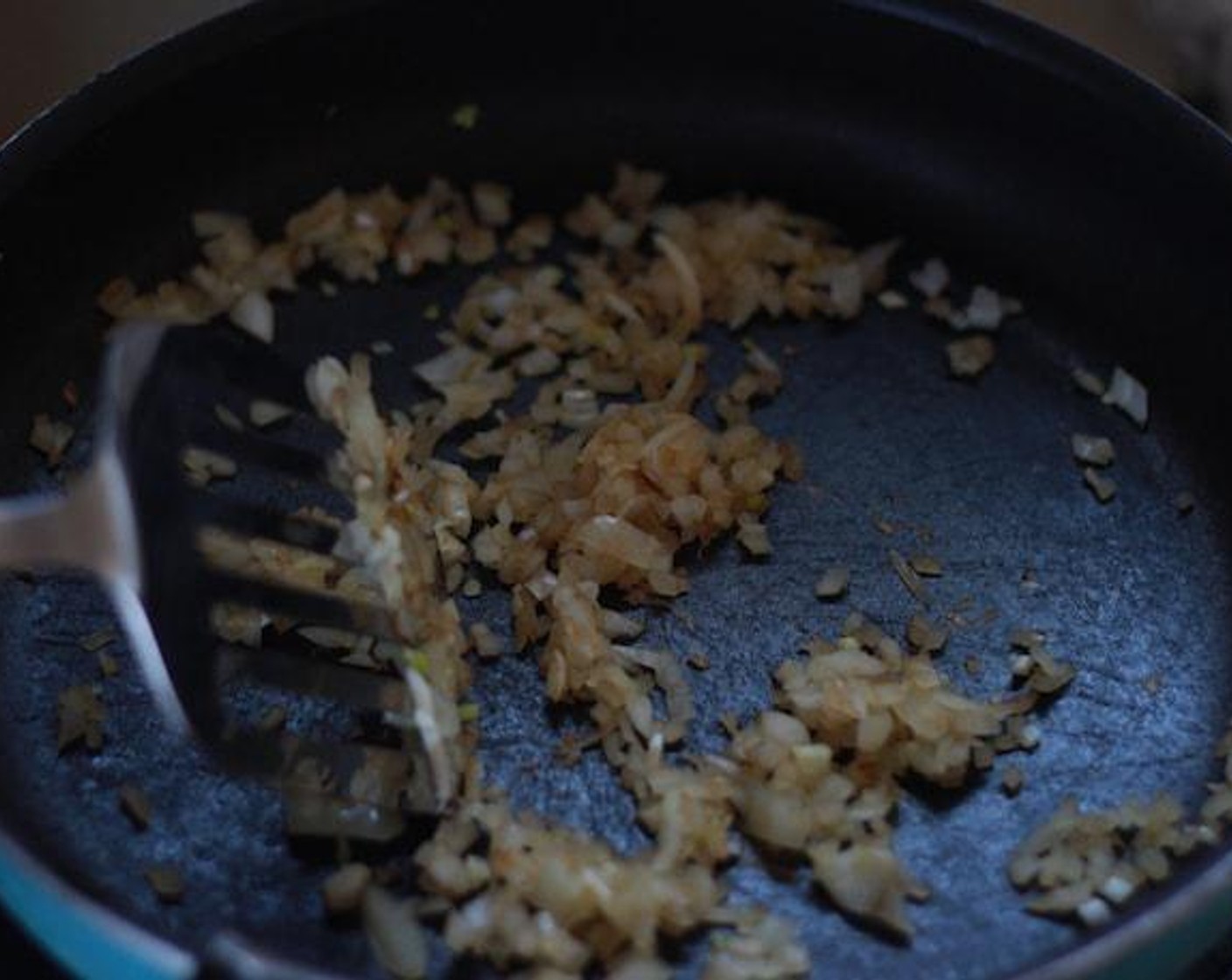 step 6 Saute the chopped garlic and onion in a pan until the onion's color turns brown.