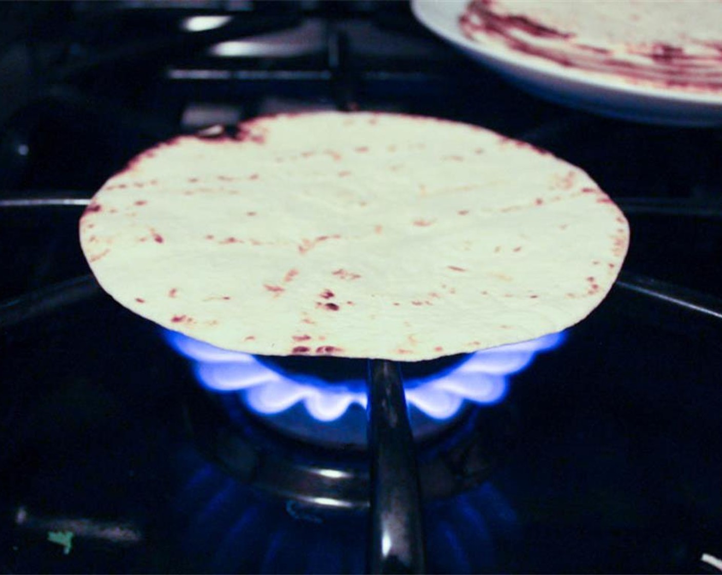 step 17 Last, but not least, warm the 6-Inch Flour Tortillas (8). I like to do this by placing the tortillas on the eye of the burner for about 10 seconds on each side until they get slightly charred. Use tongs.