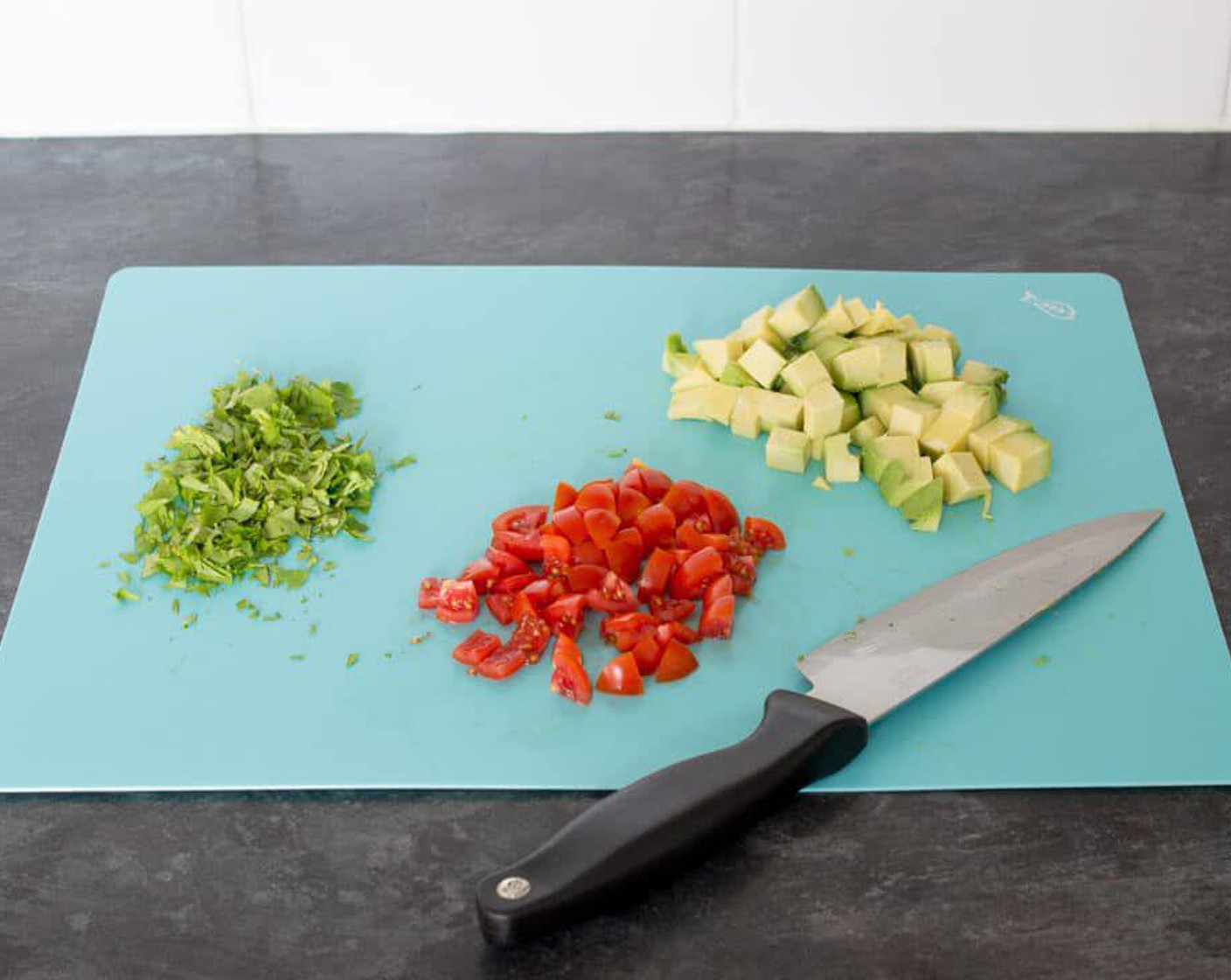 step 1 Halve the Avocado (1) and remove the stone. Cut into quarters, peel off the skin & then chop into cubes. Chop the Tomatoes (2) into small pieces or quarter if you are using cherry tomatoes.