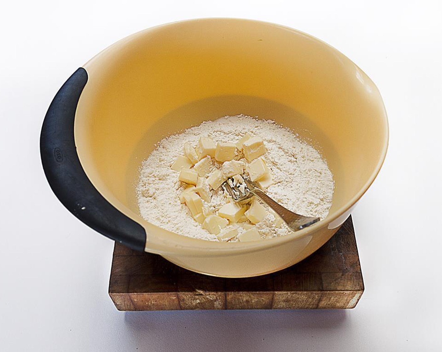 step 5 Cut in the Butter (1/2 cup) until the mixture is crumbly. Add the Water (4 Tbsp), stirring with a fork until the flour is moistened. Add up to 2 tbsp of water if the dough seems dry. Gently knead until the dough comes together and forms into a ball.