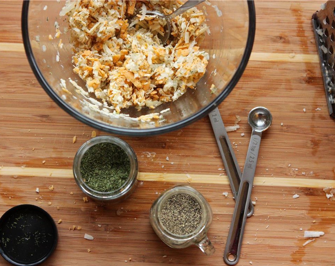 step 7 When the dough has about 15 minutes left to raise, combine grated onion and cheeses, Dried Dill Weed (1 tsp), Sea Salt (1/2 tsp), and Ground Black Pepper (1/2 tsp) and mix well.