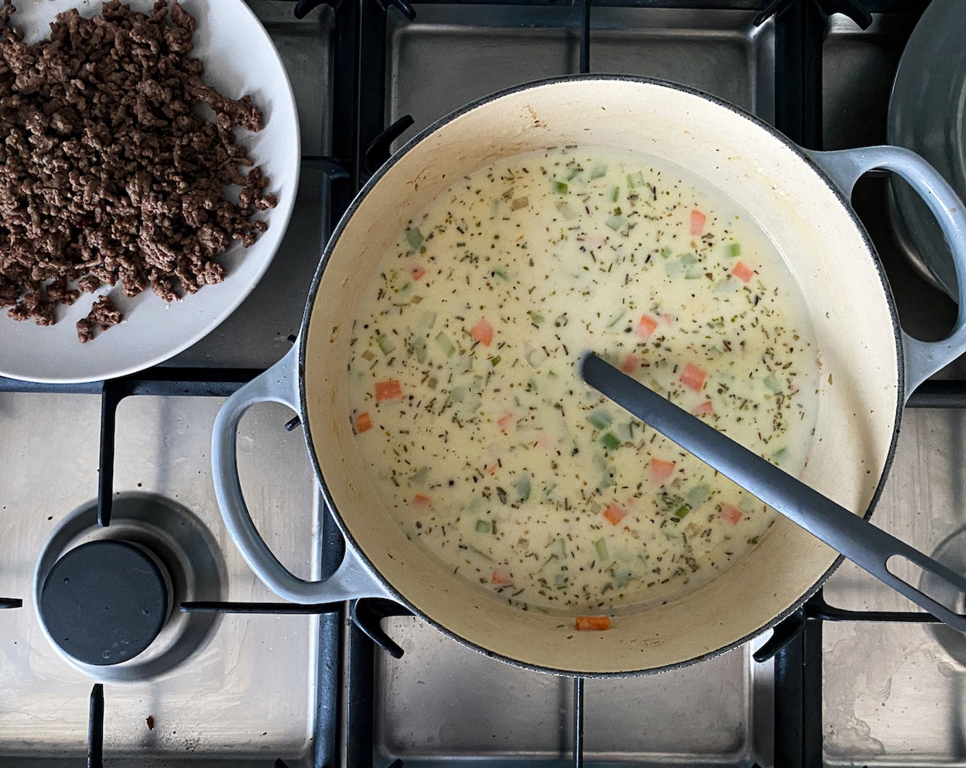 step 5 Stir in the All-Purpose Flour (1/3 cup) until well combined with the ingredients in the pot. Then add the Beef Broth (4 cups) and Milk (2 cups), and stir continuously until the mixture starts to boil.