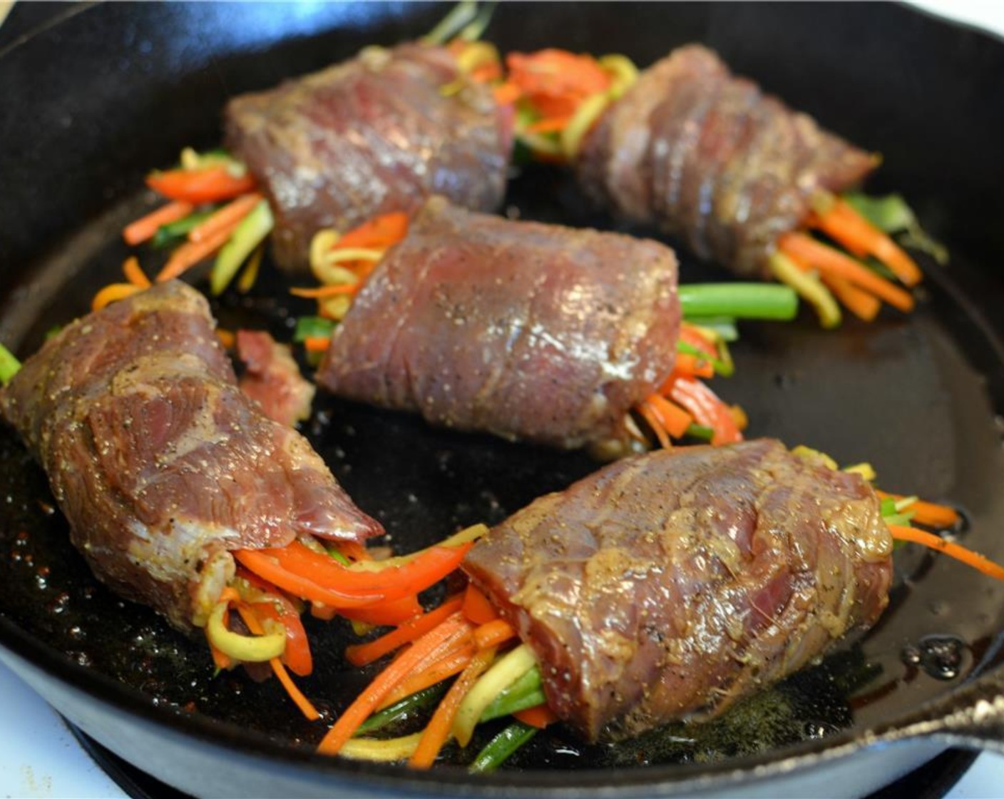 step 14 Heat a large skillet over medium-high heat. Add a touch of oil swirling to coat bottom. When hot, add beef rolls, seam side down, not touching and pan fry for a couple minutes. Then turn roll and cook it on all sides in the same way.