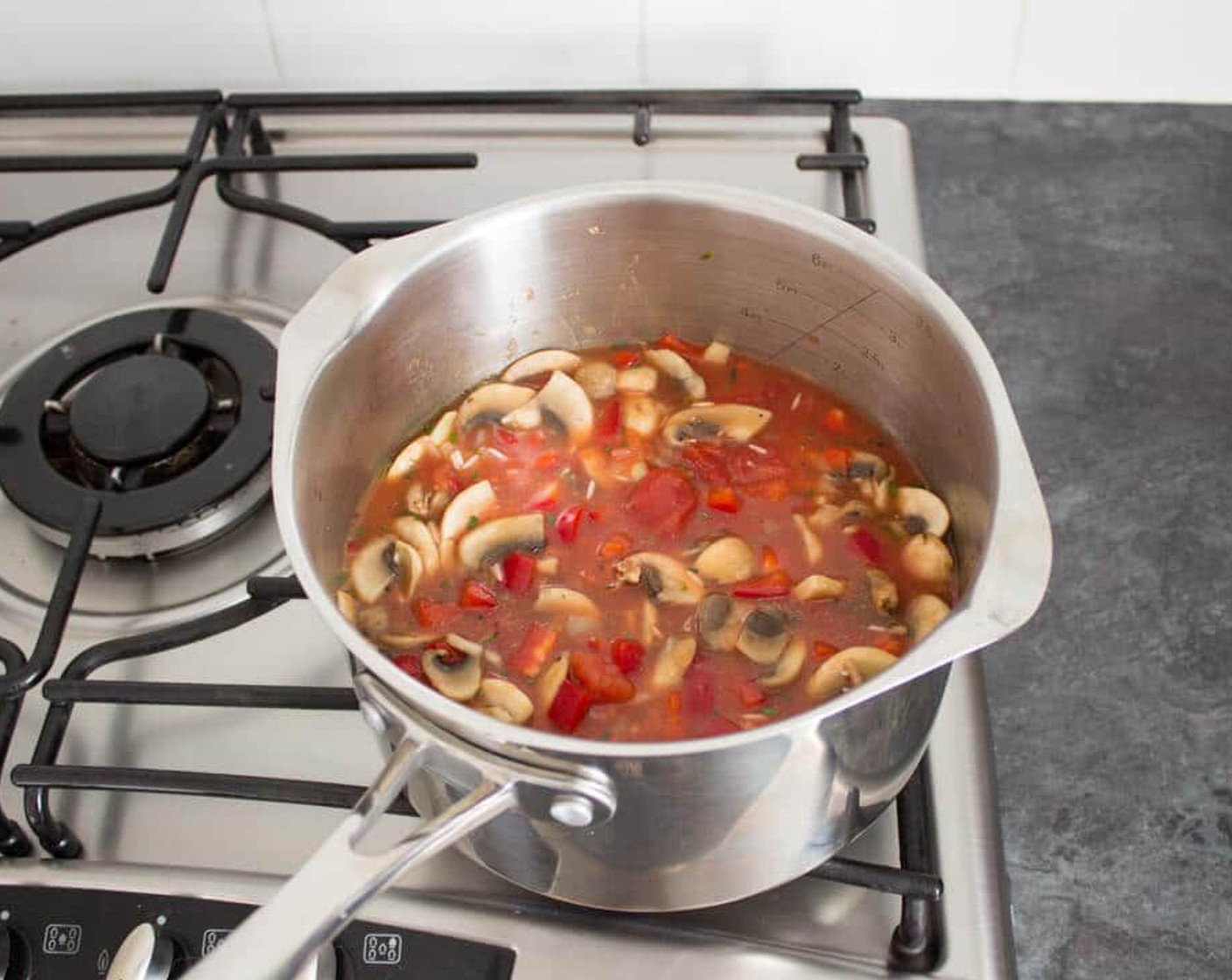 step 4 Add the rice and give it a good stir. Then throw in the Red Chili Peppers (2), Diced Tomatoes (1 can), Vegetable Stock (1 3/4 cups), Salt (to taste), and Simply Organic® Black Pepper (to taste). Bring it all to a boil and cover it with a lid.
