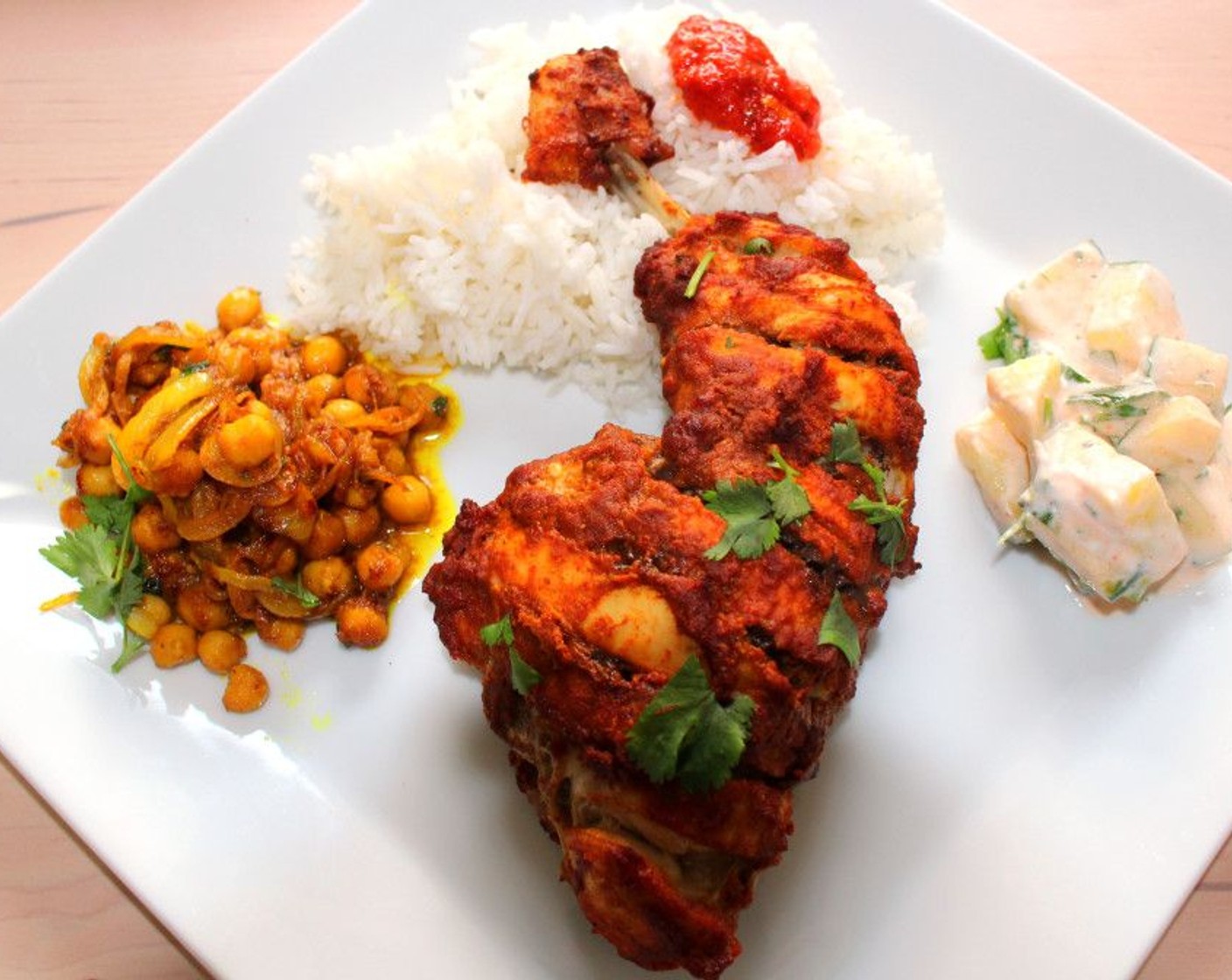 step 11 Serve the Tandoori chicken with cucumber salad, curried chickpeas and Basmati Rice (to taste).