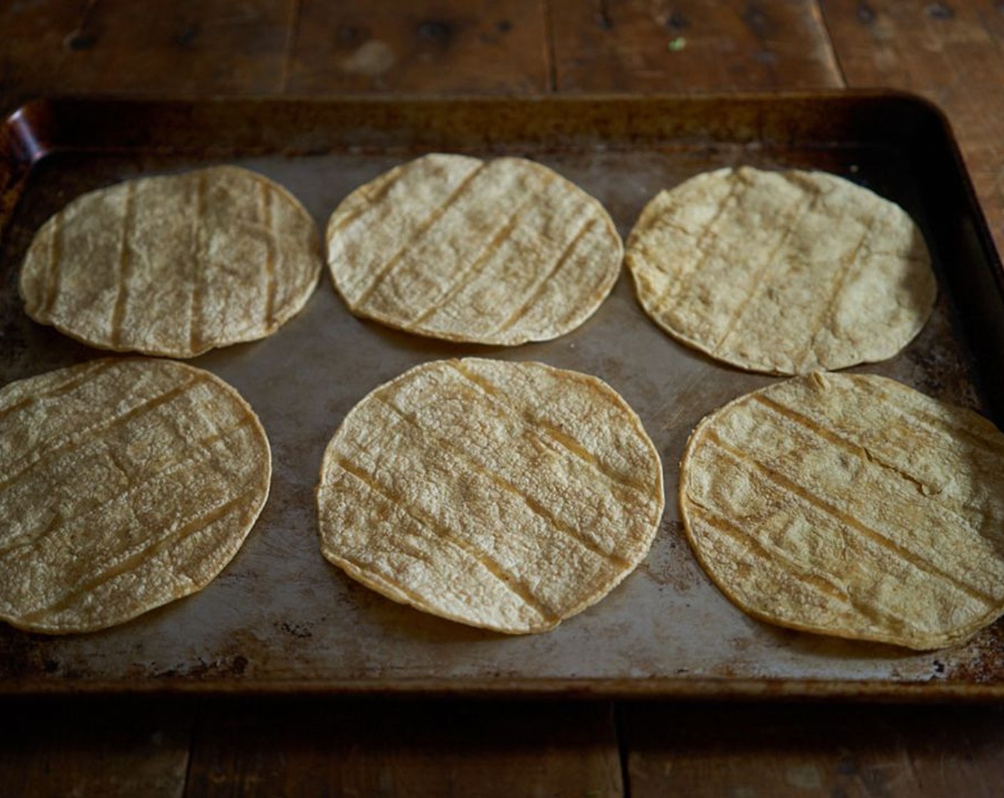 step 2 Lay Tortillas (12) flat on a baking sheet and put them in the oven for a few minutes, turning once, until they seem "stale" and a bit leathery.