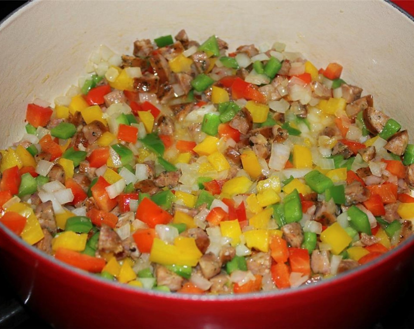 step 2 Add the Spanish Onion (1/2), Green Bell Pepper (1/2), Yellow Bell Pepper (1/2), Red Bell Pepper (1/2), and Garlic (2 cloves) and cook for 3 minutes until the vegetables are just tender and the garlic is fragrant.