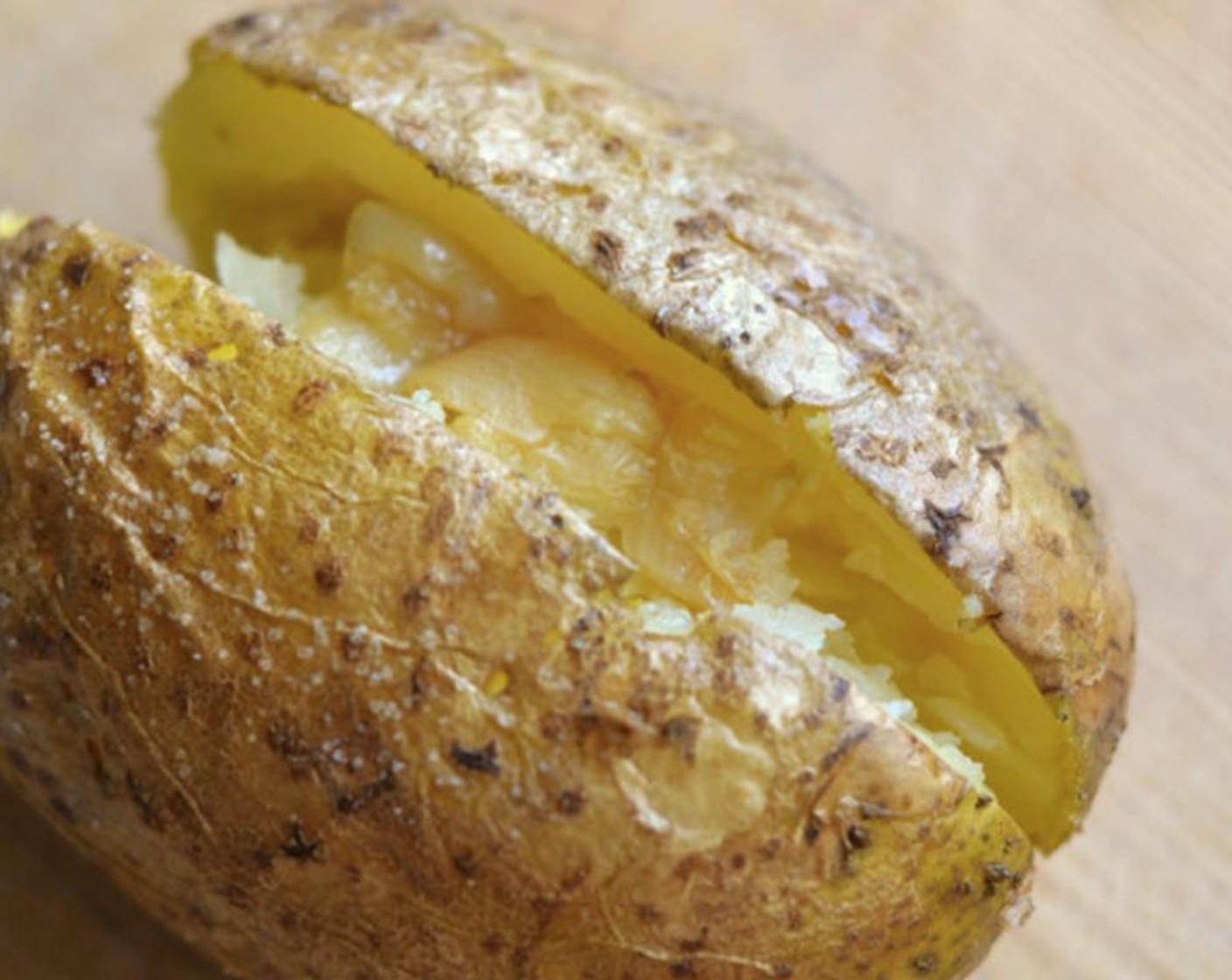 step 7 Squeeze out a couple of golden cloves from the baked garlic and use a butter knife to rub them into a creamy paste inside the potato.