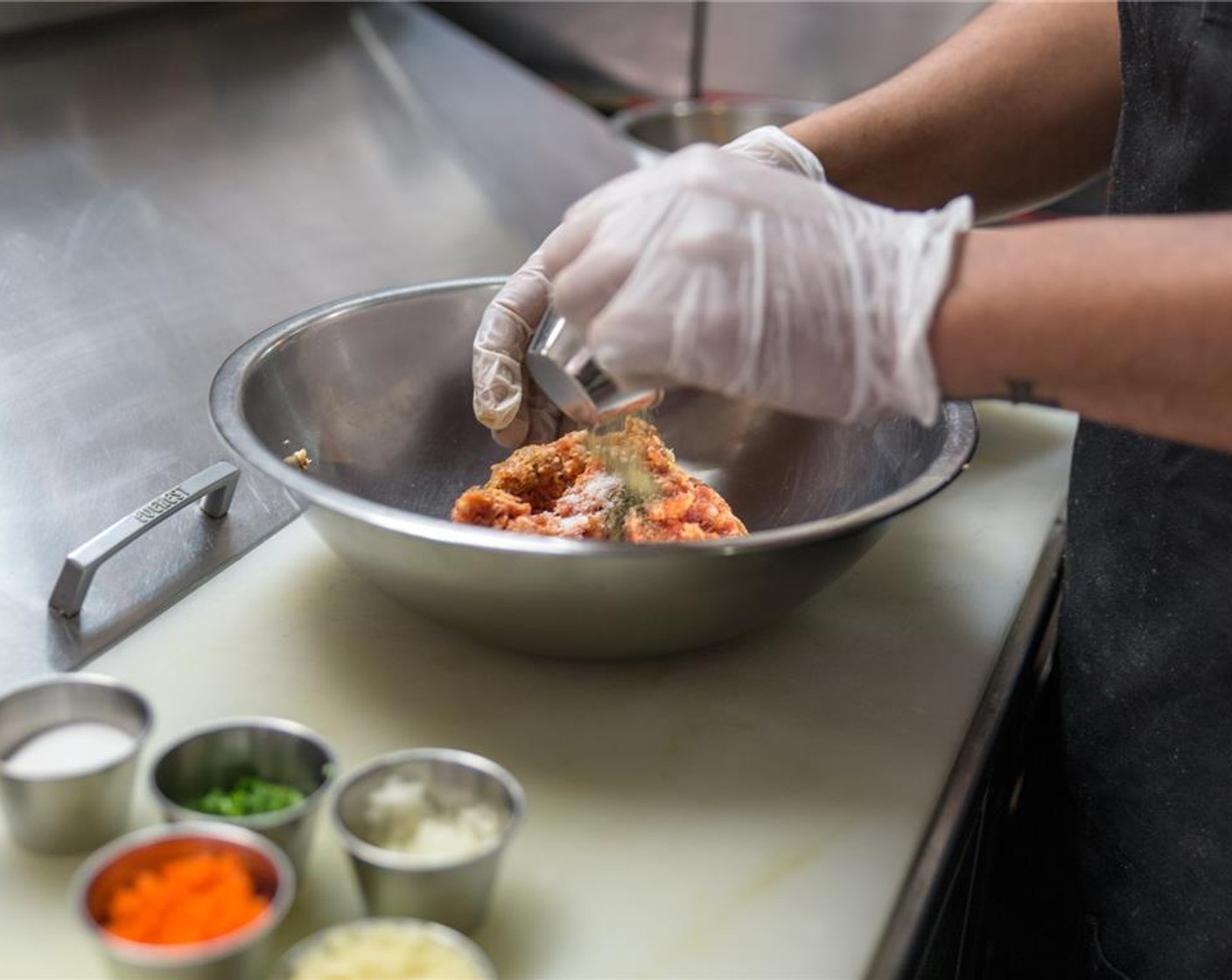 step 2 In a large mixing bowl, add the Italian Sausage Links (8 oz), Salt (1 tsp), Ground Black Pepper (1 tsp), carrot, Granulated Sugar (1 Tbsp), garlic, onion, cilantro, Poultry Seasoning (1 Tbsp), and lastly Sesame Oil (2 Tbsp). Mix together.