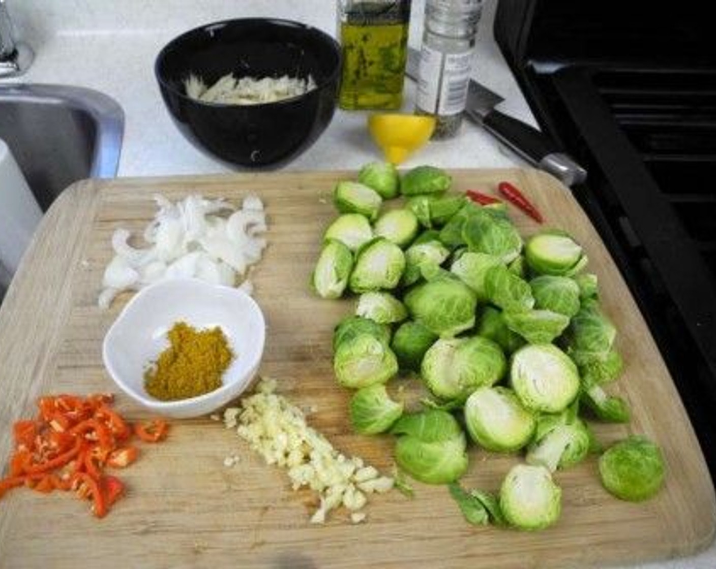 step 1 Wash the Brussels Sprouts (5 cups) with cool water, pat dry, trim off  any stems and cut each one in half. Also dice the Garlic (3 cloves), Pimiento Pepper (1), and Onion (1).