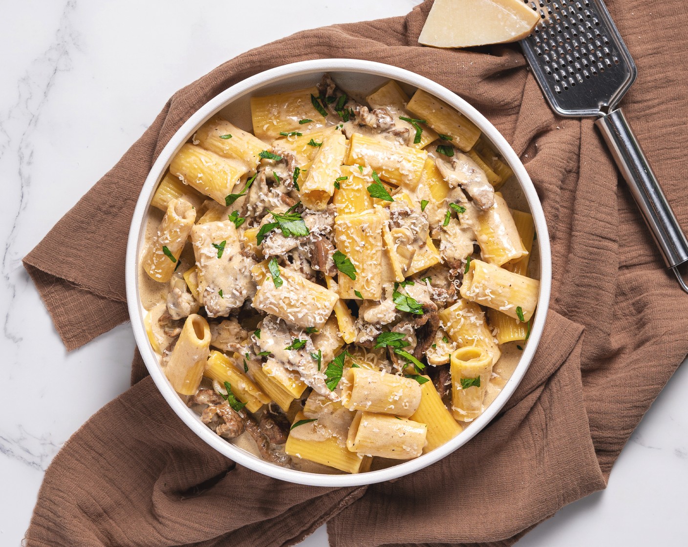 step 8 Transfer to a serving dish. Top the pasta dish with shredded parmesan and optionally garnish with Italian Flat-Leaf Parsley (to taste). Serve immediately!