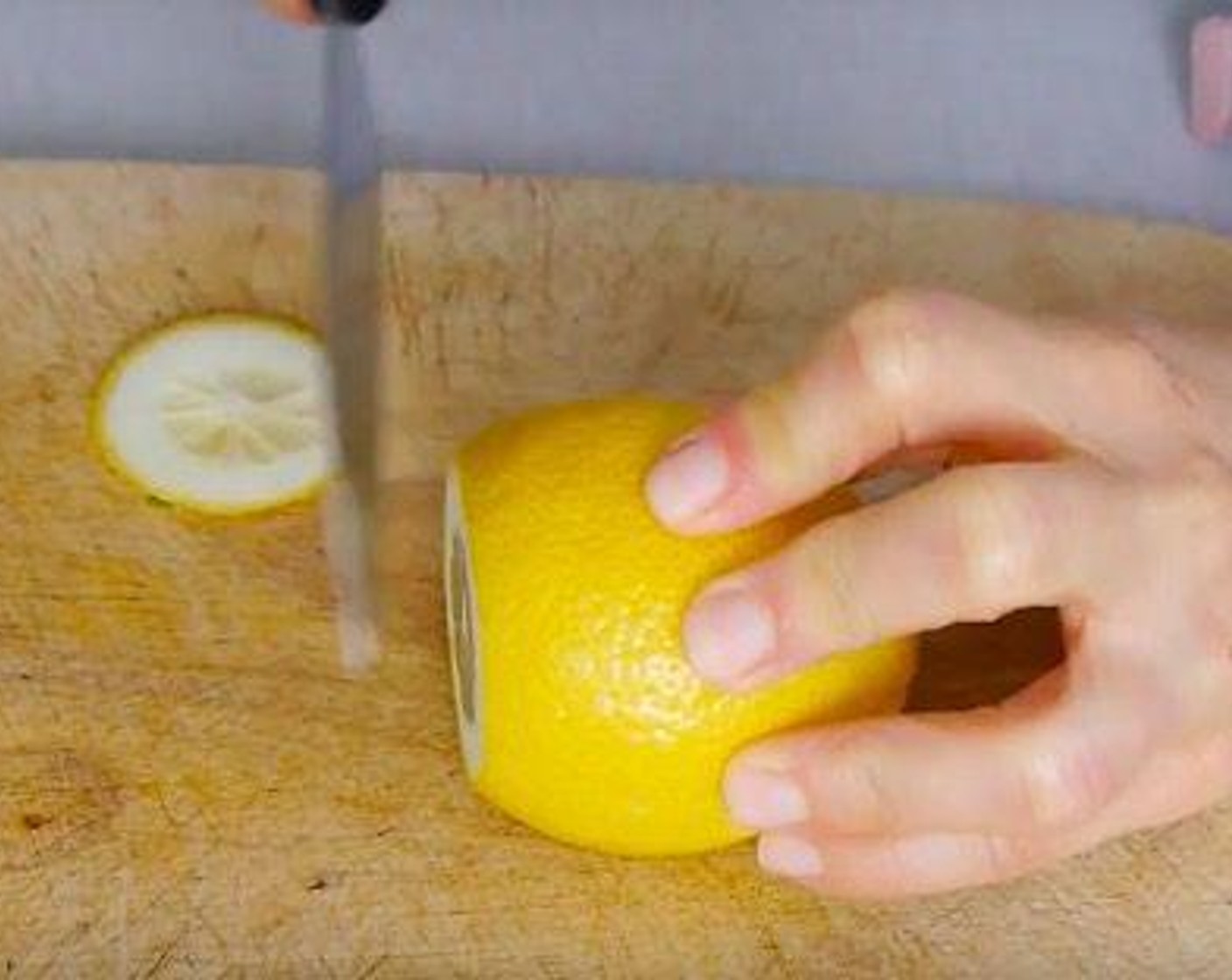 step 3 Whilst the chicken is marinating slice Lemons (2 1/2) and Lime (1) and start to put together the dish ready for the oven.