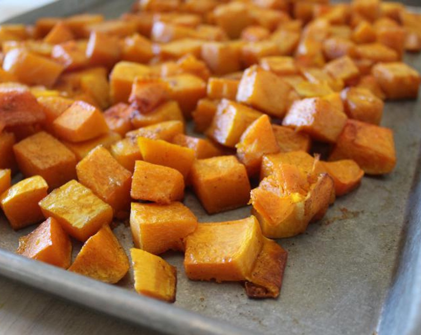 step 2 Place the Butternut Squash (1) on a sheet pan, add Extra-Virgin Olive Oil (2 Tbsp), Ground Cinnamon (1/2 Tbsp), and Kosher Salt (to taste) and toss lightly with your hands.