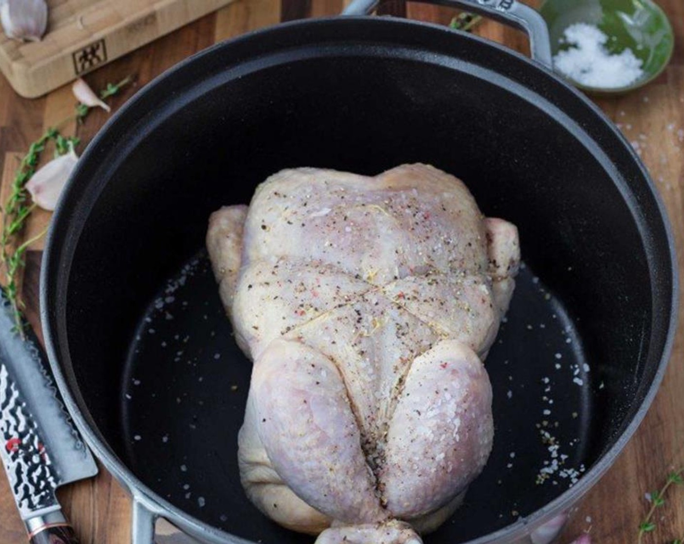 step 6 Place the trussed bird at the bottom of a Dutch oven or oven-safe skillet (cast-iron is perfect for this) and transfer into the preheated oven.
