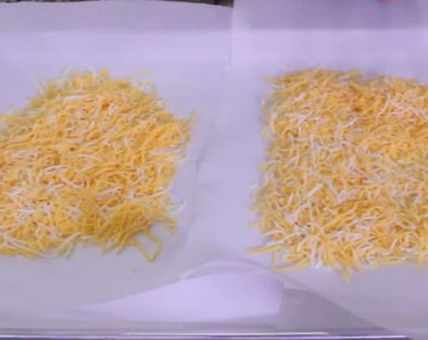 step 3 On a Large Baking Sheet, cover it with 2 pieces of Parchment Paper cut in half. Place the Shredded Mexican Cheese Blend (2 cups) onto the baking sheet in 2 equal sized piles.